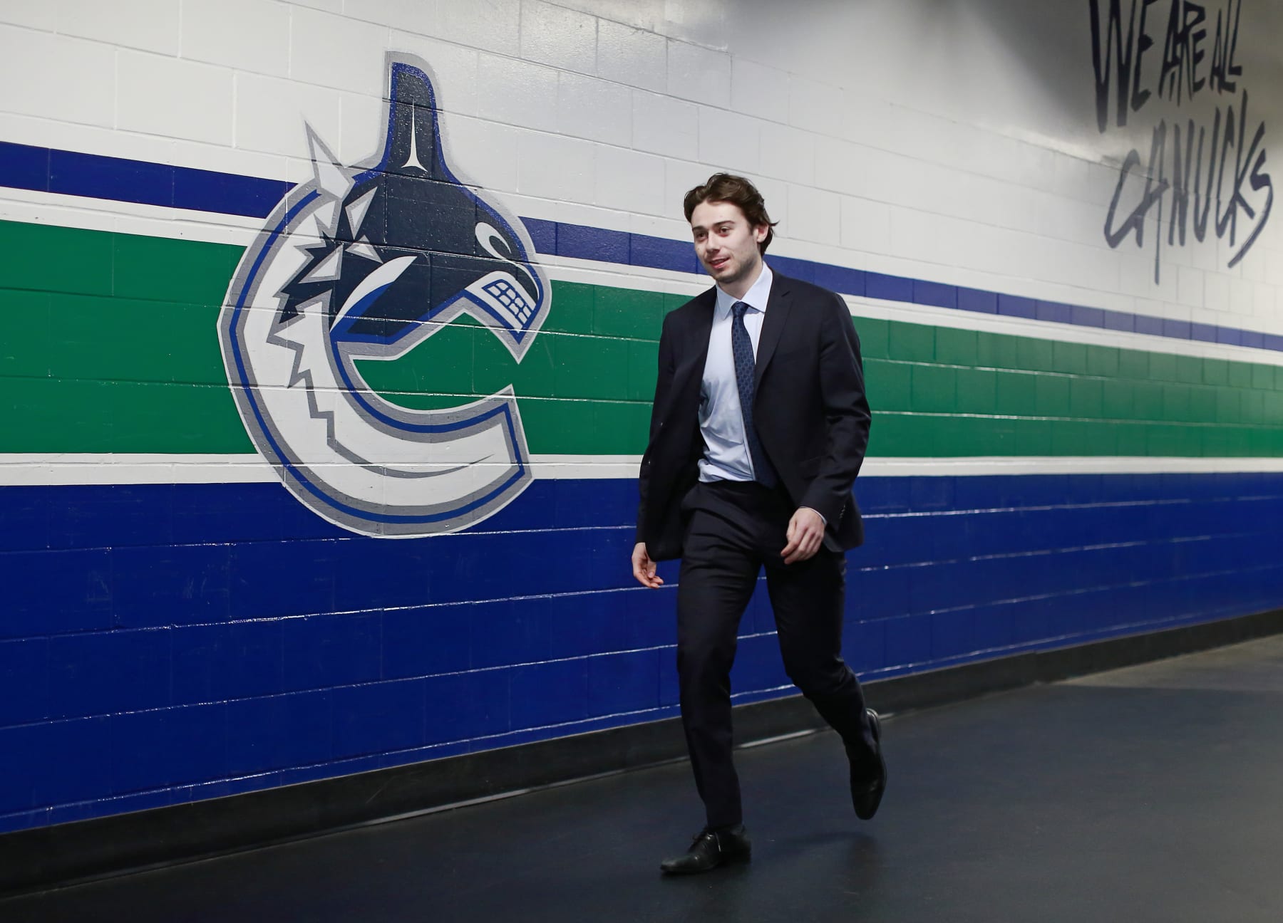 VANCOUVER, BC - APRIL 14: Quinn Hughes #43 of the Vancouver Canucks walks to the Canucks dressing room before their NHL game against the Arizona Coyotes at Rogers Arena April 14, 2022 in Vancouver, British Columbia, Canada.  (Photo by Jeff Vinnick/NHLI via Getty Images)