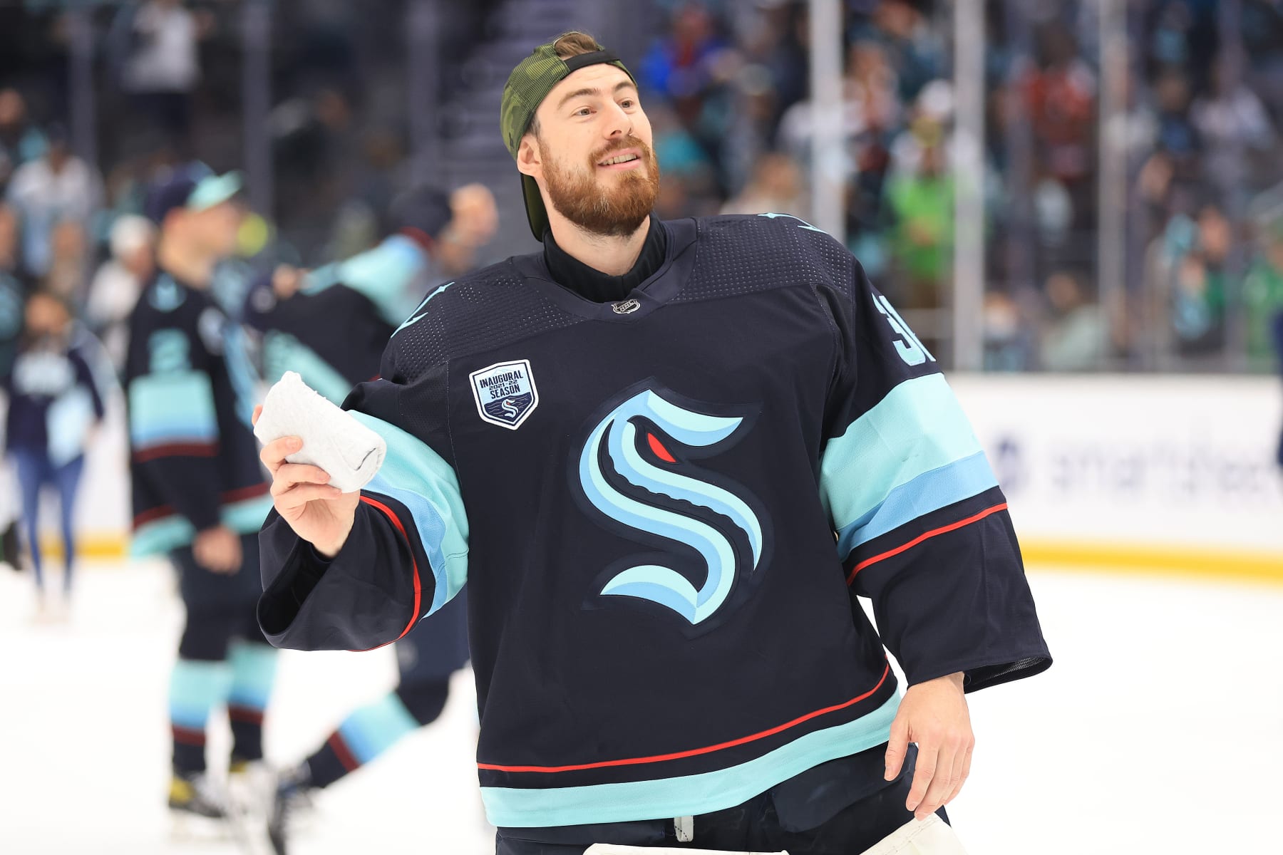 SEATTLE, WASHINGTON - APRIL 29: Philipp Grubauer #31 of the Seattle Kraken looks to throw a t-shirt to fans as a part of Fan Appreciation Night following the 3-0 win against the San Jose Sharks at Climate Pledge Arena on April 29, 2022 in Seattle, Washington. (Photo by Abbie Parr/2022 NHLI via Getty Images)
