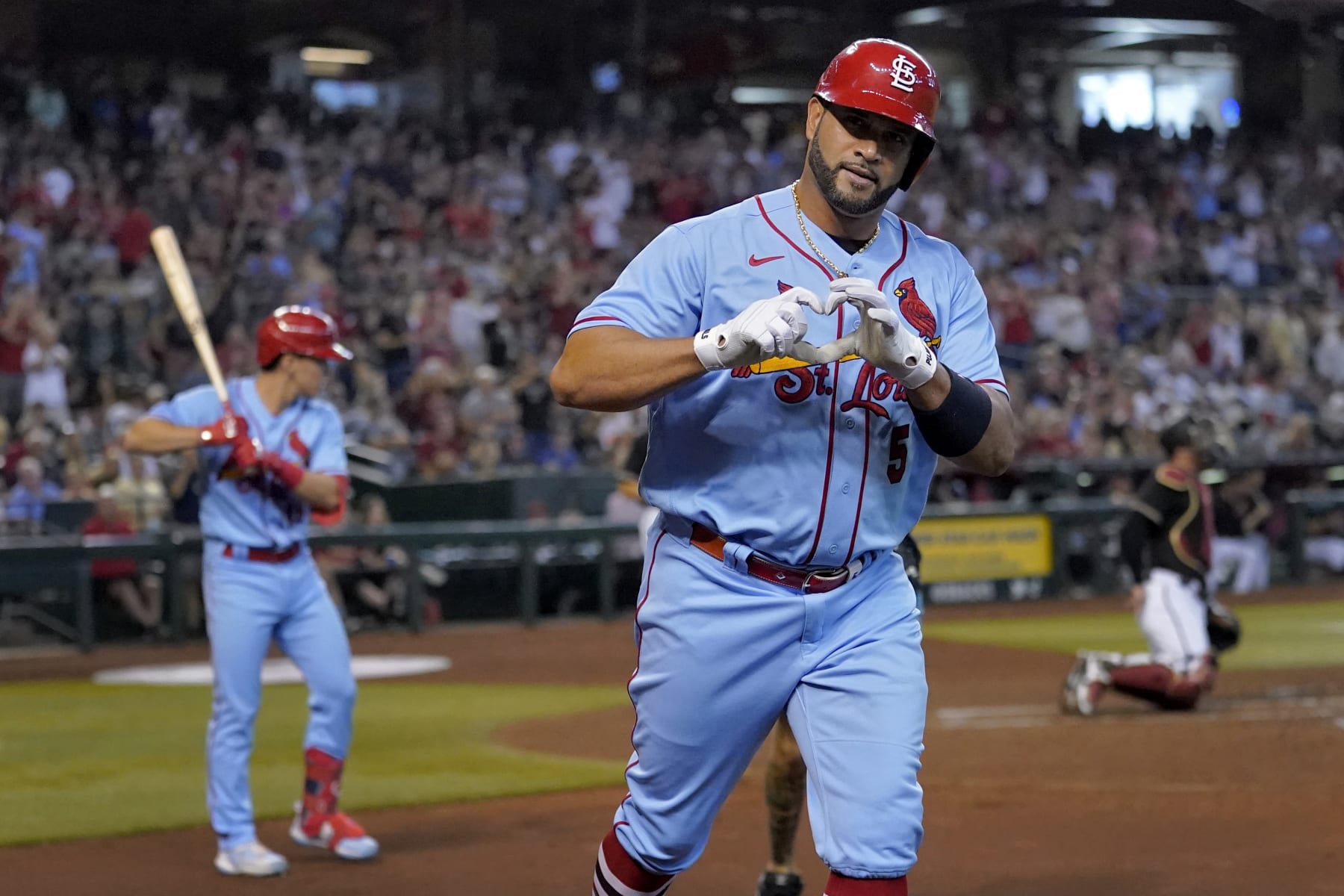 St. Louis Cardinals' Albert Pujols celebrates his solo home run against the Arizona Diamondbacks during the second inning of a baseball game, Saturday, Aug. 20, 2022, in Phoenix. (AP Photo/Matt York)