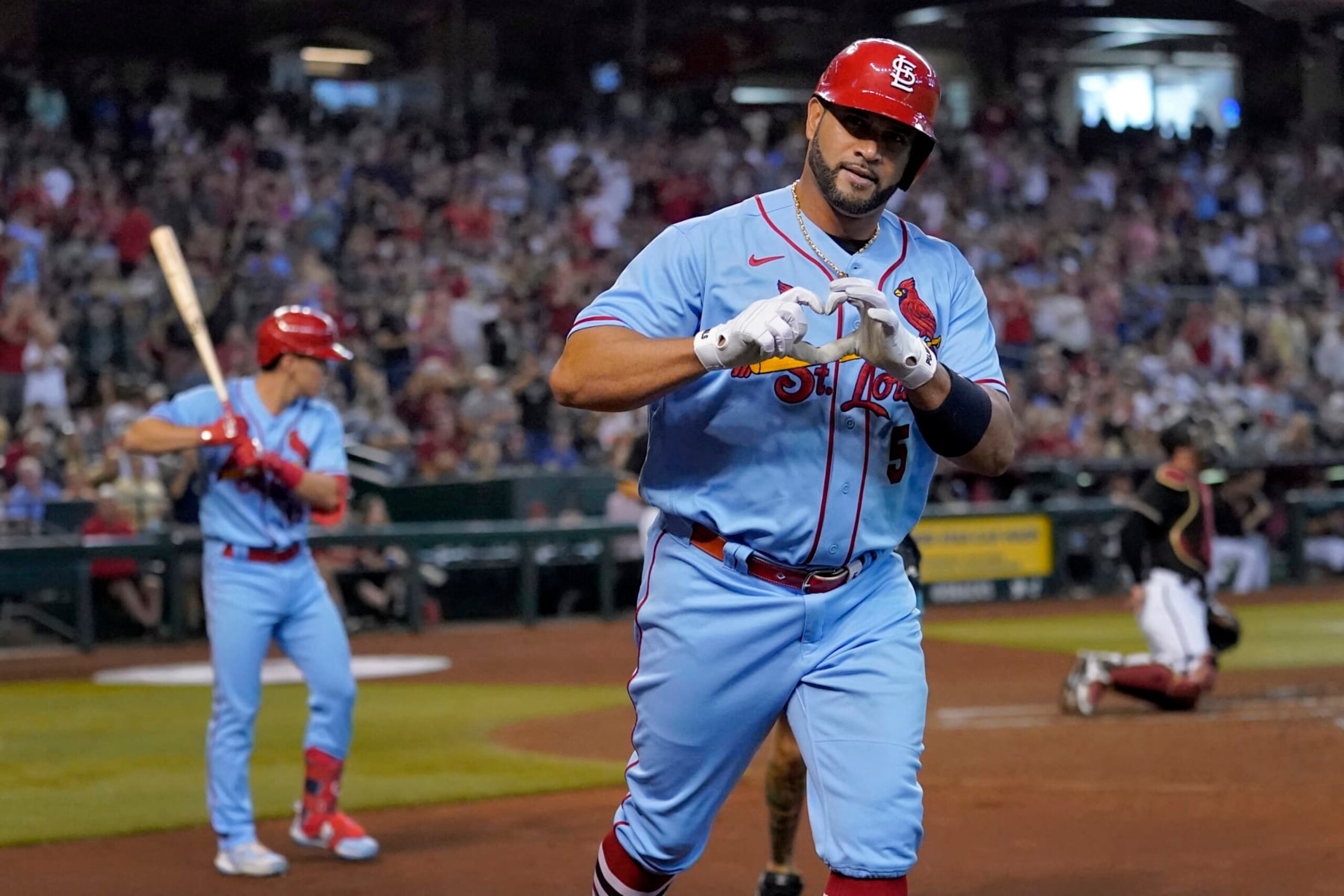 St. Louis Cardinals' Albert Pujols celebrates his solo home run against the Arizona Diamondbacks during the second inning of a baseball game, Saturday, Aug. 20, 2022, in Phoenix. (AP Photo/Matt York)