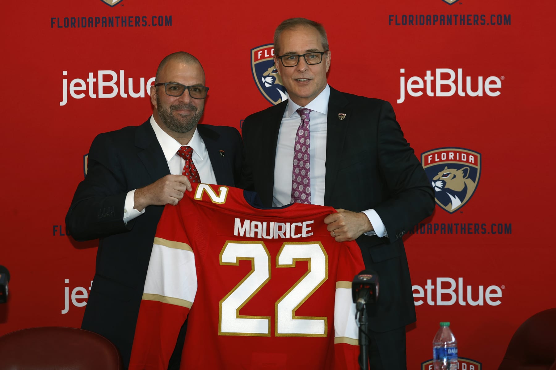 SUNRISE, FL - JUNE 23: General manager Bill Zito presents Paul Maurice with a team jersey after he was introduced as the new head coach of the Florida Panthers at the FLA Live Arena on June 23, 2022 in Sunrise, Florida. (Photo by Joel Auerbach/Getty Images)