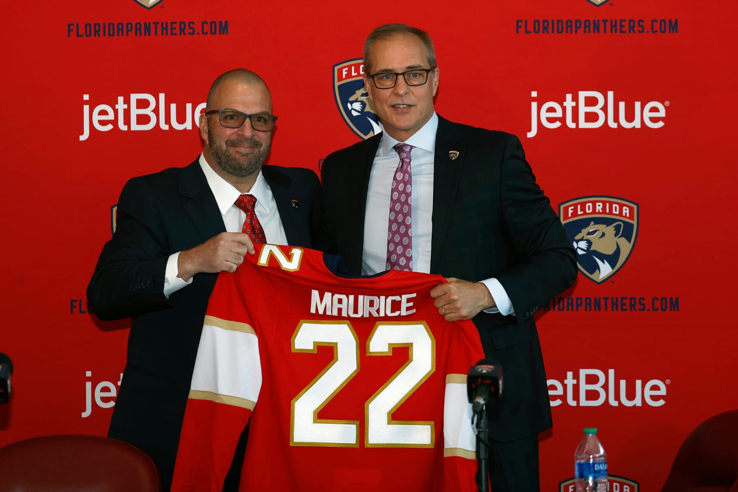 SUNRISE, FL - JUNE 23: General manager Bill Zito presents Paul Maurice with a team jersey after he was introduced as the new head coach of the Florida Panthers at the FLA Live Arena on June 23, 2022 in Sunrise, Florida. (Photo by Joel Auerbach/Getty Images) SUNRISE, FL - JUNE 23: General manager Bill Zito presents Paul Maurice with a team jersey after he was introduced as the new head coach of the Florida Panthers at the FLA Live Arena on June 23, 2022 in Sunrise, Florida. (Photo by Joel Auerbach/Getty Images)
