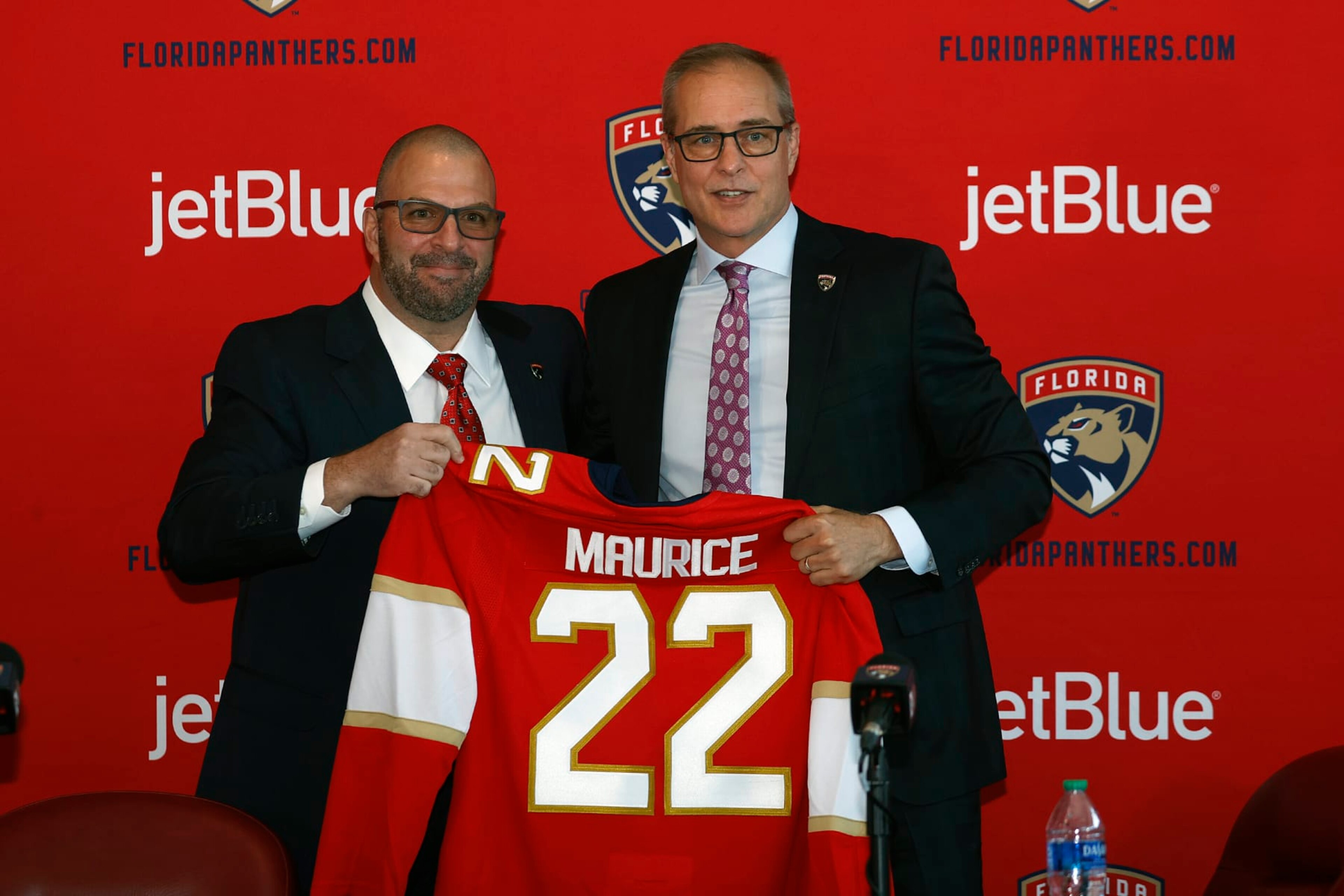 SUNRISE, FL - JUNE 23: General manager Bill Zito presents Paul Maurice with a team jersey after he was introduced as the new head coach of the Florida Panthers at the FLA Live Arena on June 23, 2022 in Sunrise, Florida. (Photo by Joel Auerbach/Getty Images) SUNRISE, FL - JUNE 23: General manager Bill Zito presents Paul Maurice with a team jersey after he was introduced as the new head coach of the Florida Panthers at the FLA Live Arena on June 23, 2022 in Sunrise, Florida. (Photo by Joel Auerbach/Getty Images)