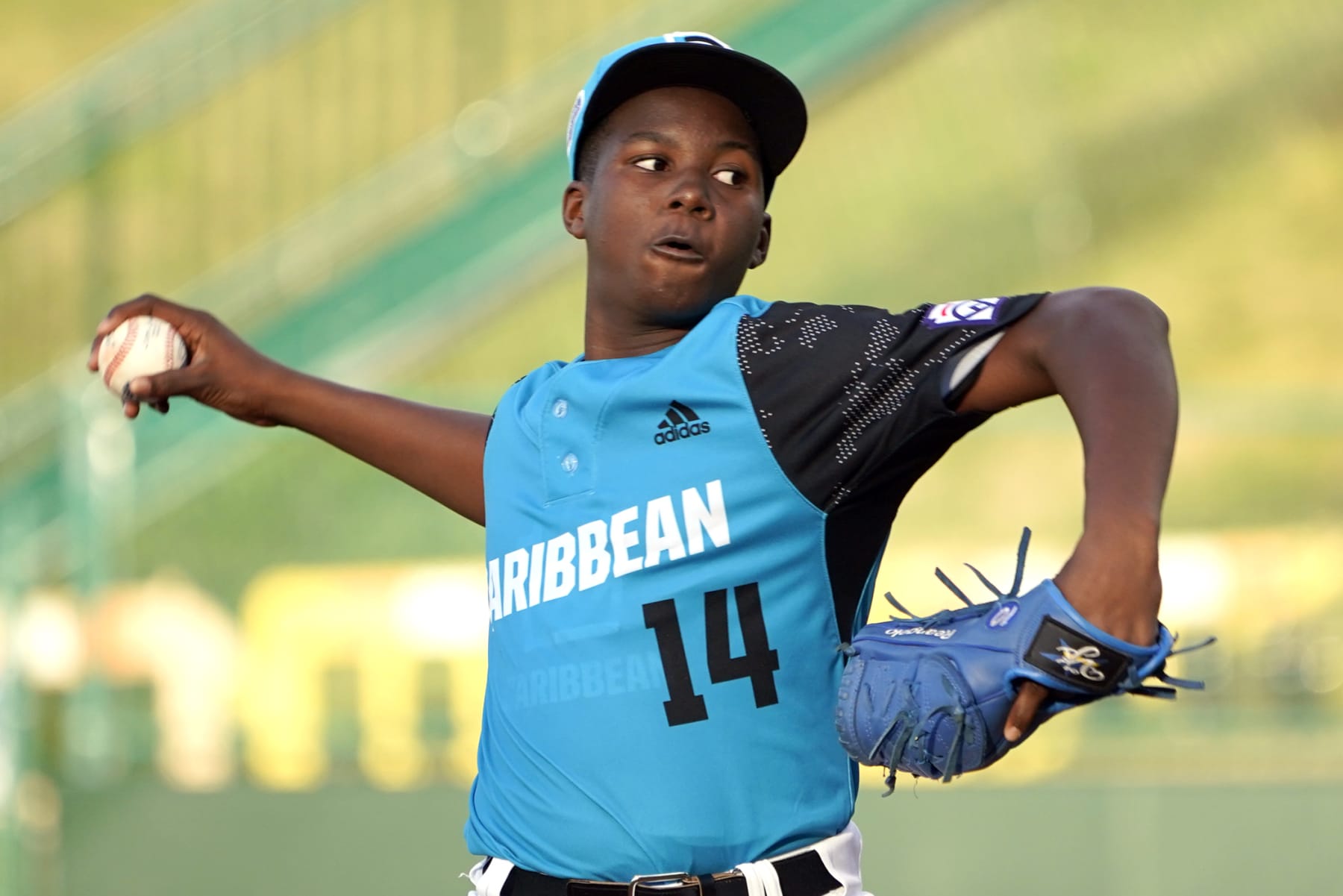 Curacao starting pitch Reangelo Decaster (14) delivers a pitch against Canada during the first inning of a baseball game at the Little League World Series tournament in South Williamsport, Pa., Tuesday, Aug. 23, 2022. Curacao won the game 4-2. (AP Photo/Tom E. Puskar)