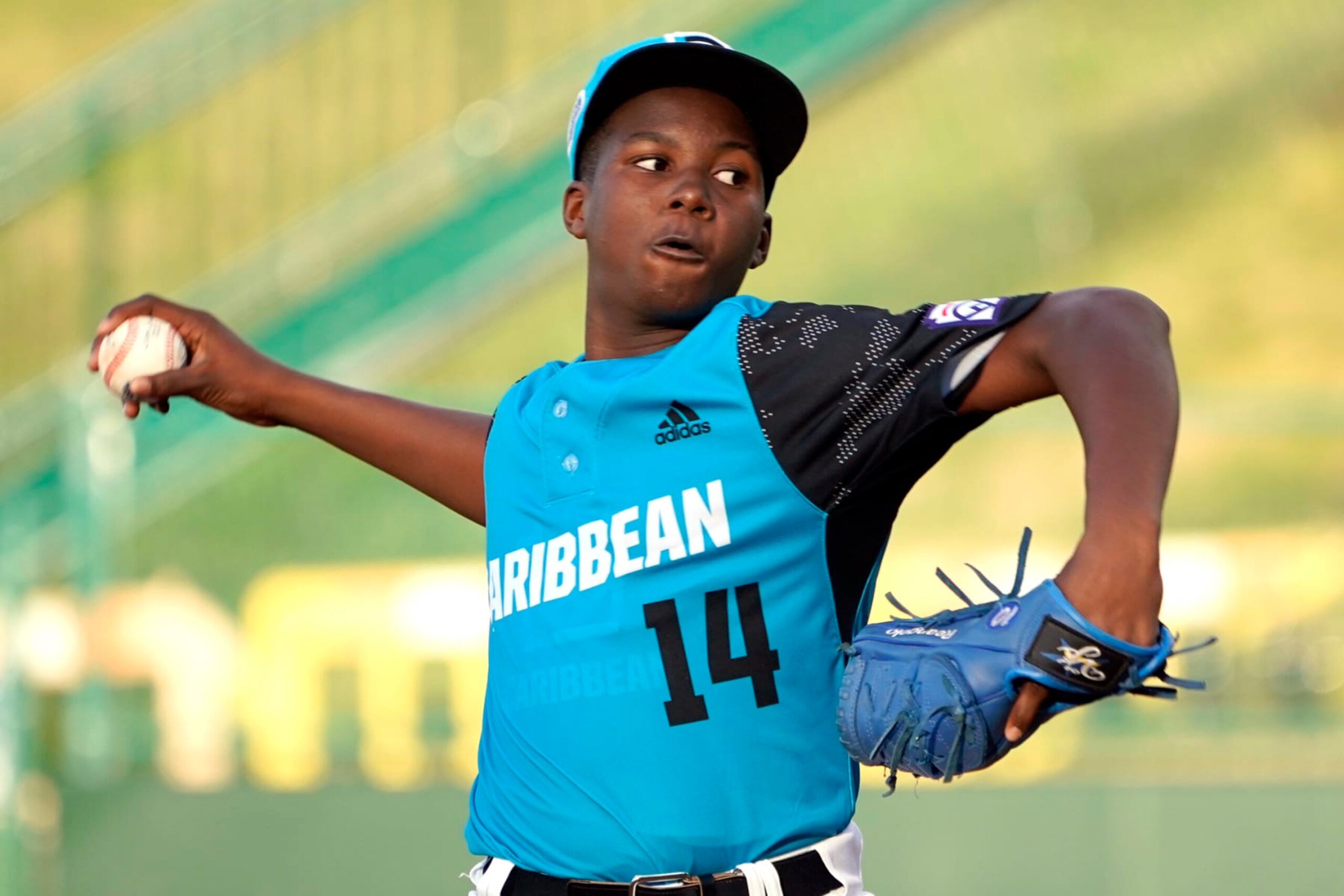 Curacao starting pitch Reangelo Decaster (14) delivers a pitch against Canada during the first inning of a baseball game at the Little League World Series tournament in South Williamsport, Pa., Tuesday, Aug. 23, 2022. Curacao won the game 4-2. (AP Photo/Tom E. Puskar)