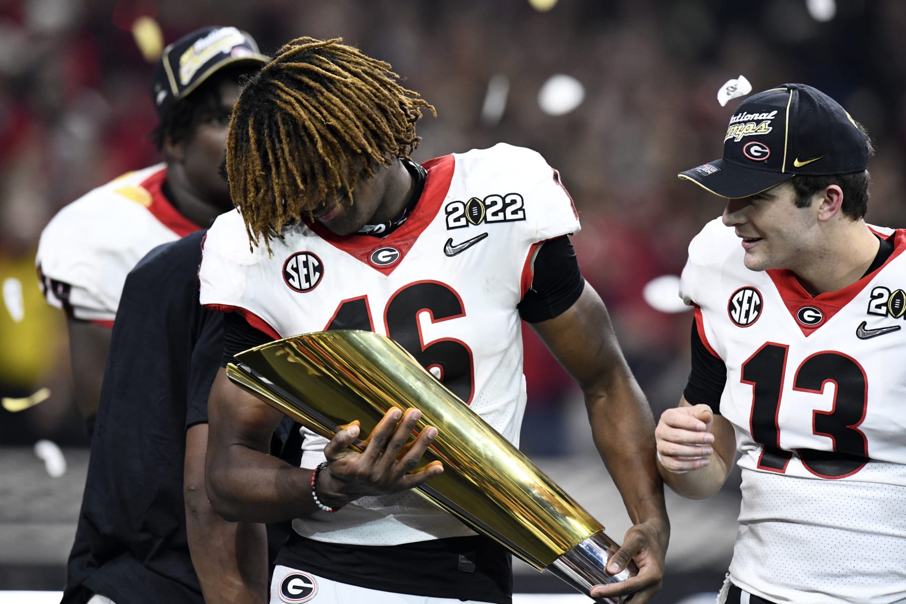 INDIANAPOLIS, IN - JANUARY 10: Georgia Bulldogs DB Lewis Cine (16) holds the National Championship Trophy at the conclusion of the Alabama Crimson Tide versus the Georgia Bulldogs in the College Football Playoff National Championship, on January 10, 2022, at Lucas Oil Stadium in Indianapolis, IN. (Photo by Michael Allio/Icon Sportswire via Getty Images)