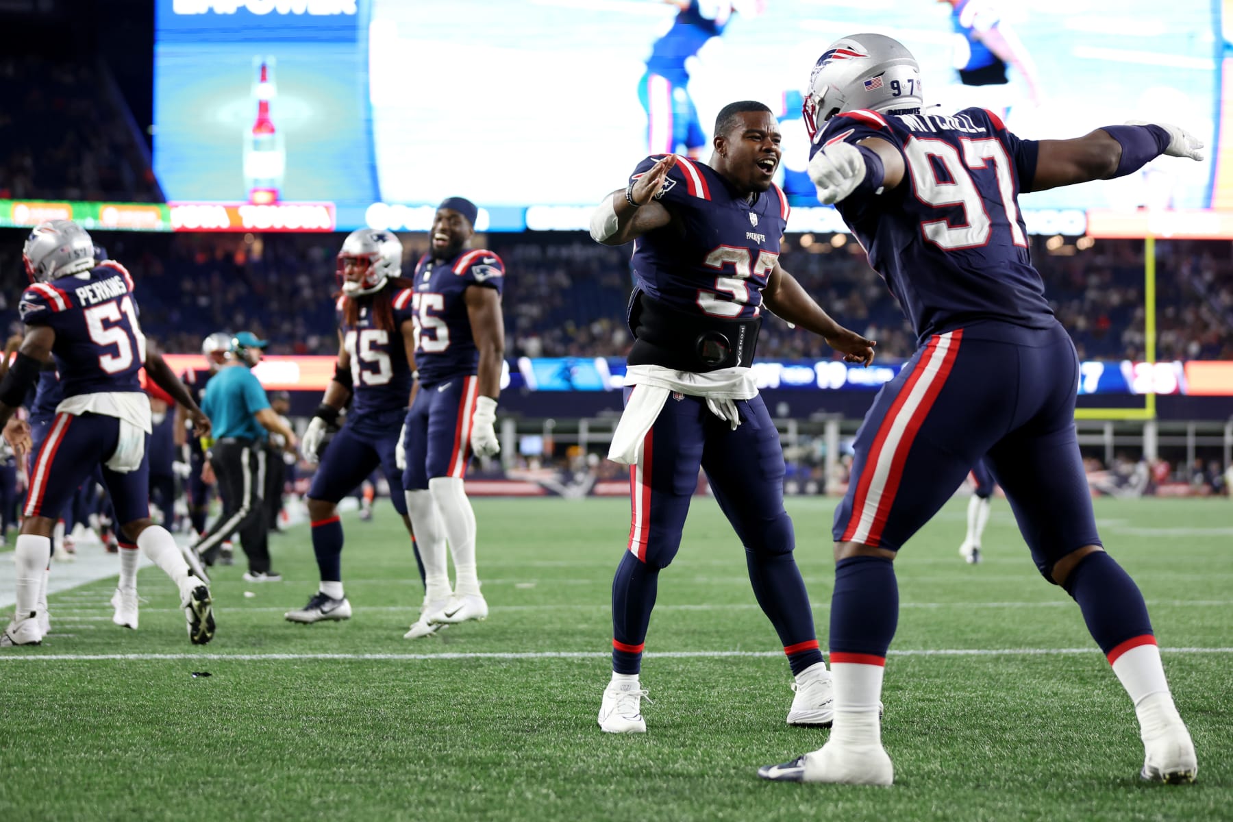 FOXBOROUGH, MASSACHUSETTS - AUGUST 19: DaMarcus Mitchell #97 celebrates with Damien Harris #37 of the New England Patriots after strip sacking PJ Walker #11 of the Carolina Panthers during the preseason game between the New England Patriots and the Carolina Panthers at Gillette Stadium on August 19, 2022 in Foxborough, Massachusetts. (Photo by Maddie Meyer/Getty Images)