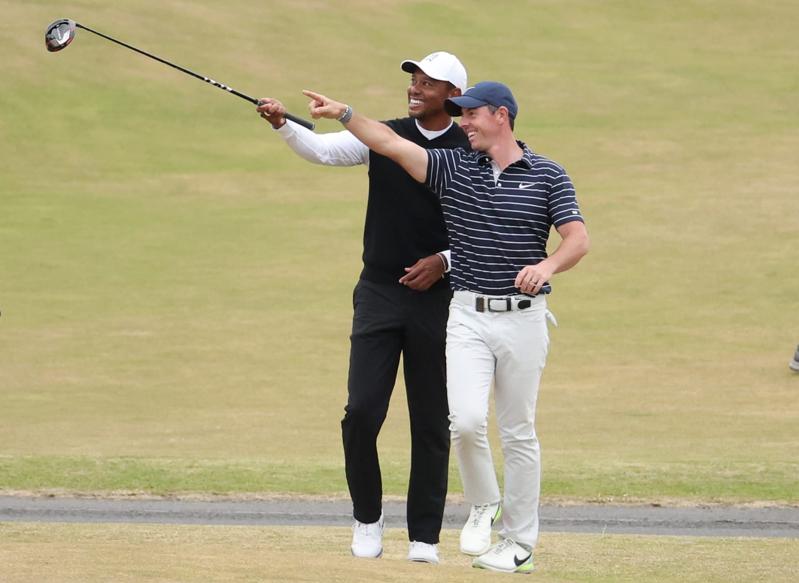 ST ANDREWS, SCOTLAND - JULY 11: Tiger Woods of The United States and Rory McIlroy of Northern Ireland interact on the 18th during the Celebration of Champions Challenge during a practice round prior to The 150th Open at St Andrews Old Course on July 11, 2022 in St Andrews, Scotland. (Photo by Warren Little/Getty Images) ST ANDREWS, SCOTLAND - JULY 11: Tiger Woods of The United States and Rory McIlroy of Northern Ireland interact on the 18th during the Celebration of Champions Challenge during a practice round prior to The 150th Open at St Andrews Old Course on July 11, 2022 in St Andrews, Scotland. (Photo by Warren Little/Getty Images)