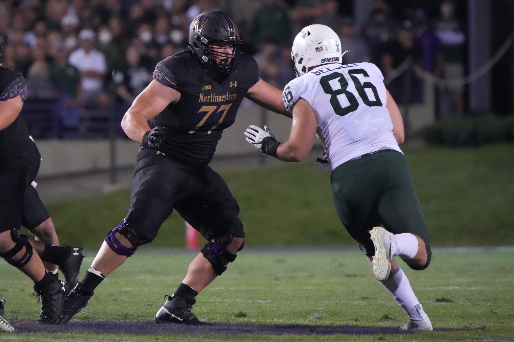 EVANSTON, IL - SEPTEMBER 03: Northwestern Wildcats offensive lineman Peter Skoronski (77) battles with Michigan State Spartans defensive end Drew Beesley (86) during a game between the Northwestern Wildcats and the Michigan State Spartans on September 3, 2021 at Ryan Field, in Evanston, IL.  (Photo by Robin Alam/Icon Sportswire via Getty Images)
