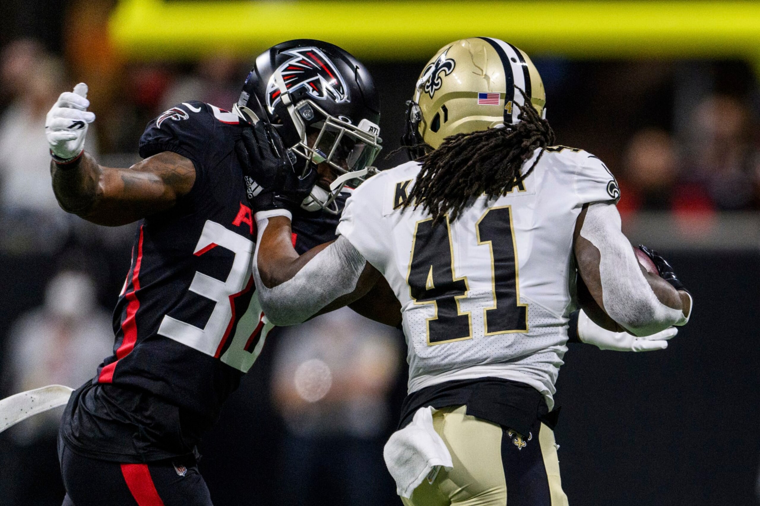 New Orleans Saints running back Alvin Kamara (41) pushes Atlanta Falcons safety Shawn Williams (36) during the first half of an NFL football game, Sunday, Jan. 9, 2022, in Atlanta. The New Orleans Saints won 30-20. (AP Photo/Danny Karnik)