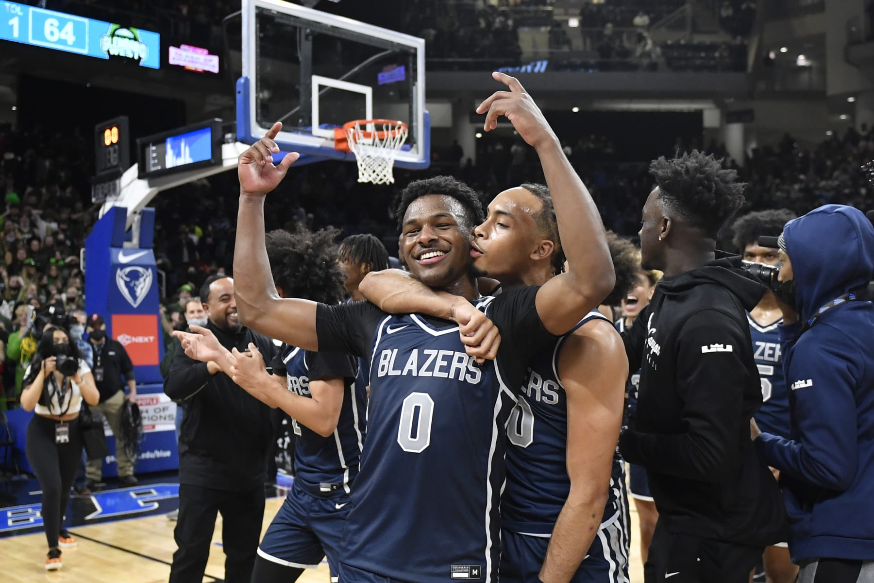 CHICAGO, ILLINOIS - FEBRUARY 05: Bronny James #0 and Amari Bailey #10 of Sierra Canyon HS celebrate after defeating Glenbard West HS at Wintrust Arena on February 05, 2022 in Chicago, Illinois. (Photo by Quinn Harris/Getty Images)