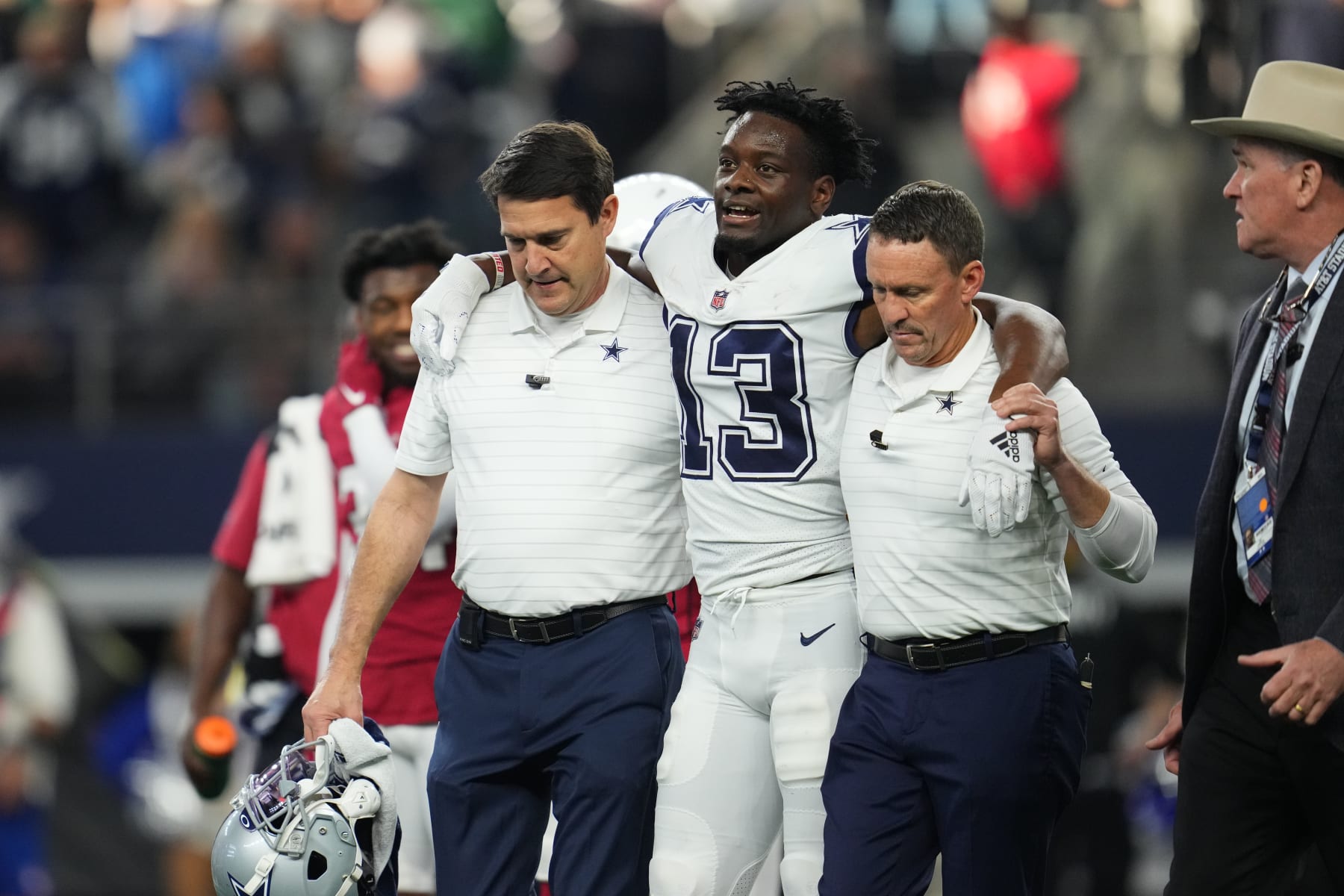 ARLINGTON, TEXAS - JANUARY 02: Michael Gallup #13 of the Dallas Cowboys walks off of the field after an injury against the Arizona Cardinals during an NFL game at AT&T Stadium on January 02, 2022 in Arlington, Texas. (Photo by Cooper Neill/Getty Images)