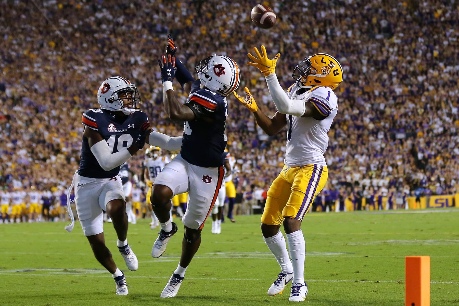BATON ROUGE, LOUISIANA - OCTOBER 02: Kayshon Boutte #1 of the LSU Tigers catches the ball for a touchdown as Nehemiah Pritchett #18 of the Auburn Tigers and Devan Barrett #10 defend during the first half at Tiger Stadium on October 02, 2021 in Baton Rouge, Louisiana. (Photo by Jonathan Bachman/Getty Images)