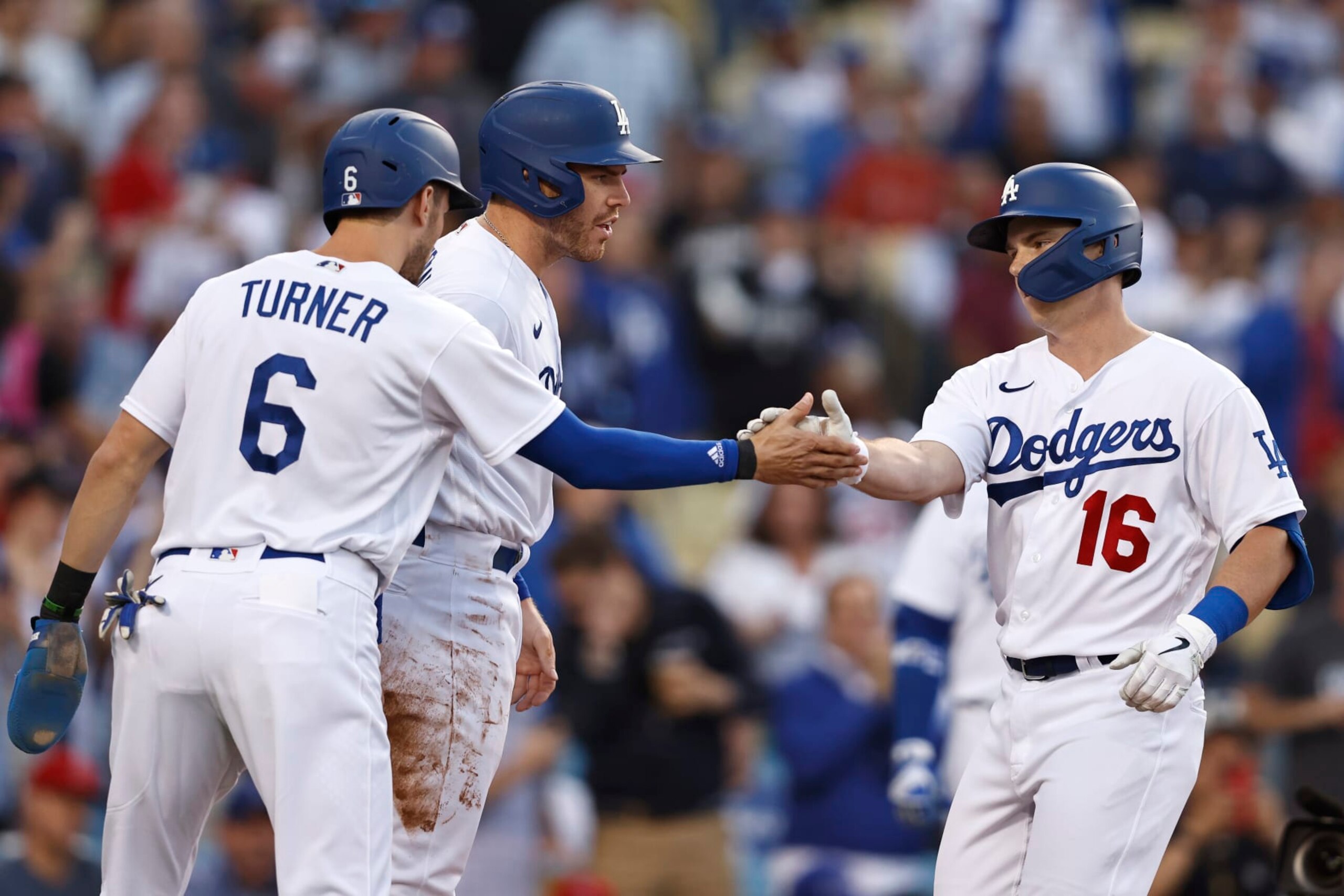 LOS ANGELES, CALIFORNIA - JUNE 15: Will Smith #16 of the Los Angeles Dodgers celebrates with teammates Trea Turner #6 and Freddie Freeman #5 after hitting a three run home run against the Los Angeles Angels during the first inning at Dodger Stadium on June 15, 2022 in Los Angeles, California. (Photo by Michael Owens/Getty Images)