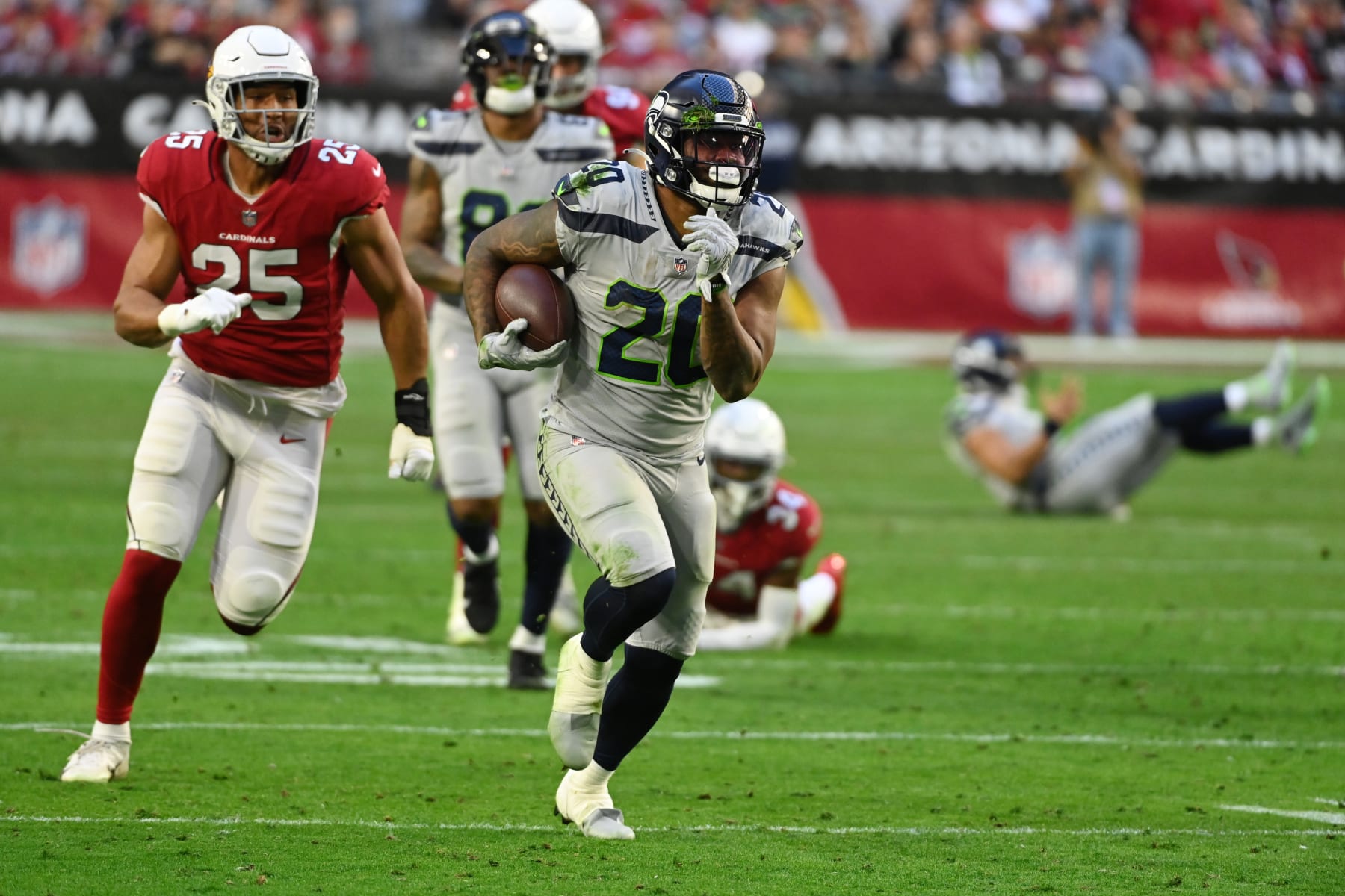 GLENDALE, ARIZONA - JANUARY 09: Rashaad Penny #20 of the Seattle Seahawks runs with the ball against the Arizona Cardinals at State Farm Stadium on January 09, 2022 in Glendale, Arizona. (Photo by Norm Hall/Getty Images)