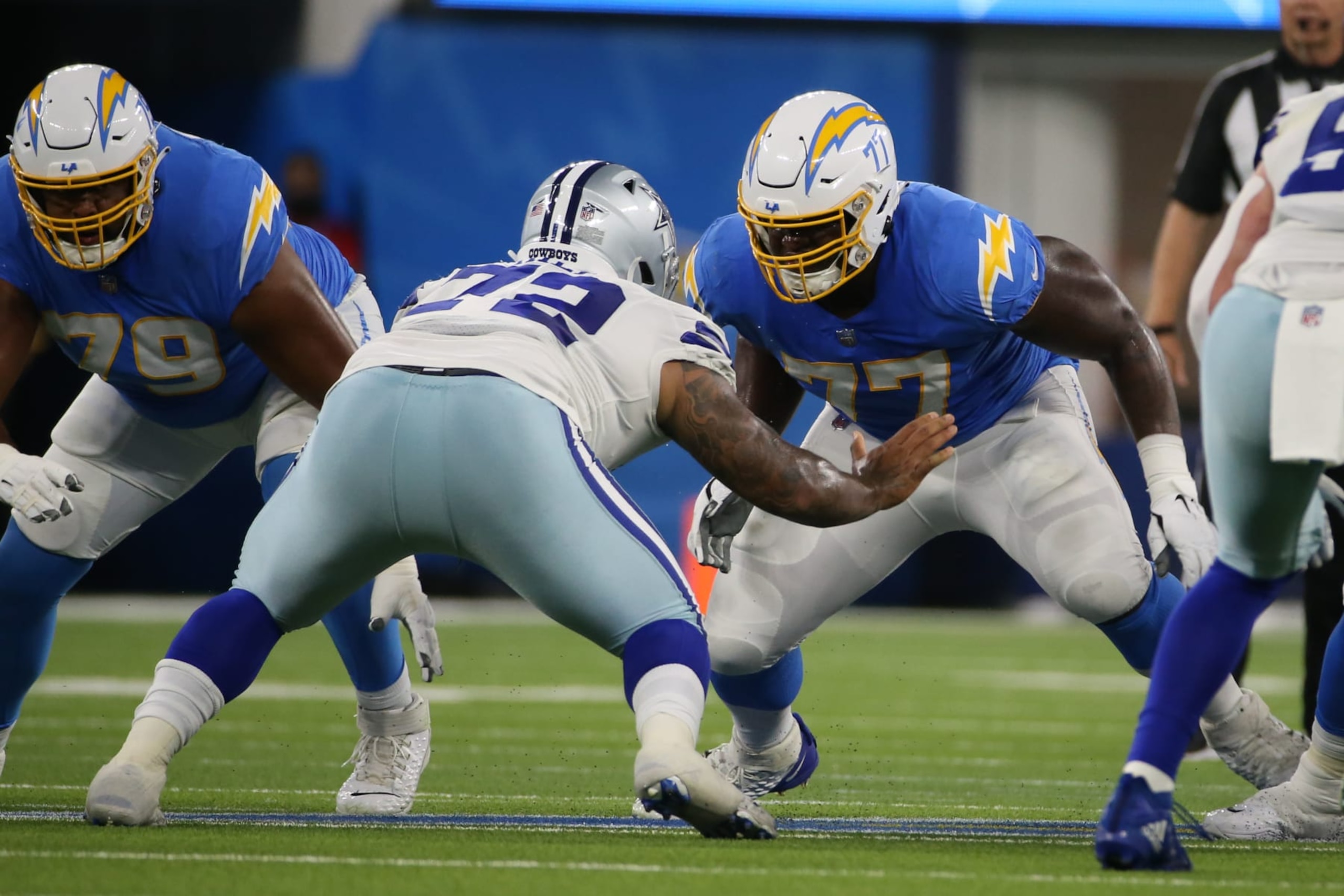 INGLEWOOD, CA - AUGUST 20: Los Angeles Chargers guard Zion Johnson (77) fires out to block during the NFL preseason game between the Dallas Cowboys and the Los Angeles Chargers on August 20, 2022, at SoFi Stadium in Inglewood, CA. (Photo by Jevone Moore/Icon Sportswire via Getty Images) INGLEWOOD, CA - AUGUST 20: Los Angeles Chargers guard Zion Johnson (77) fires out to block during the NFL preseason game between the Dallas Cowboys and the Los Angeles Chargers on August 20, 2022, at SoFi Stadium in Inglewood, CA. (Photo by Jevone Moore/Icon Sportswire via Getty Images)