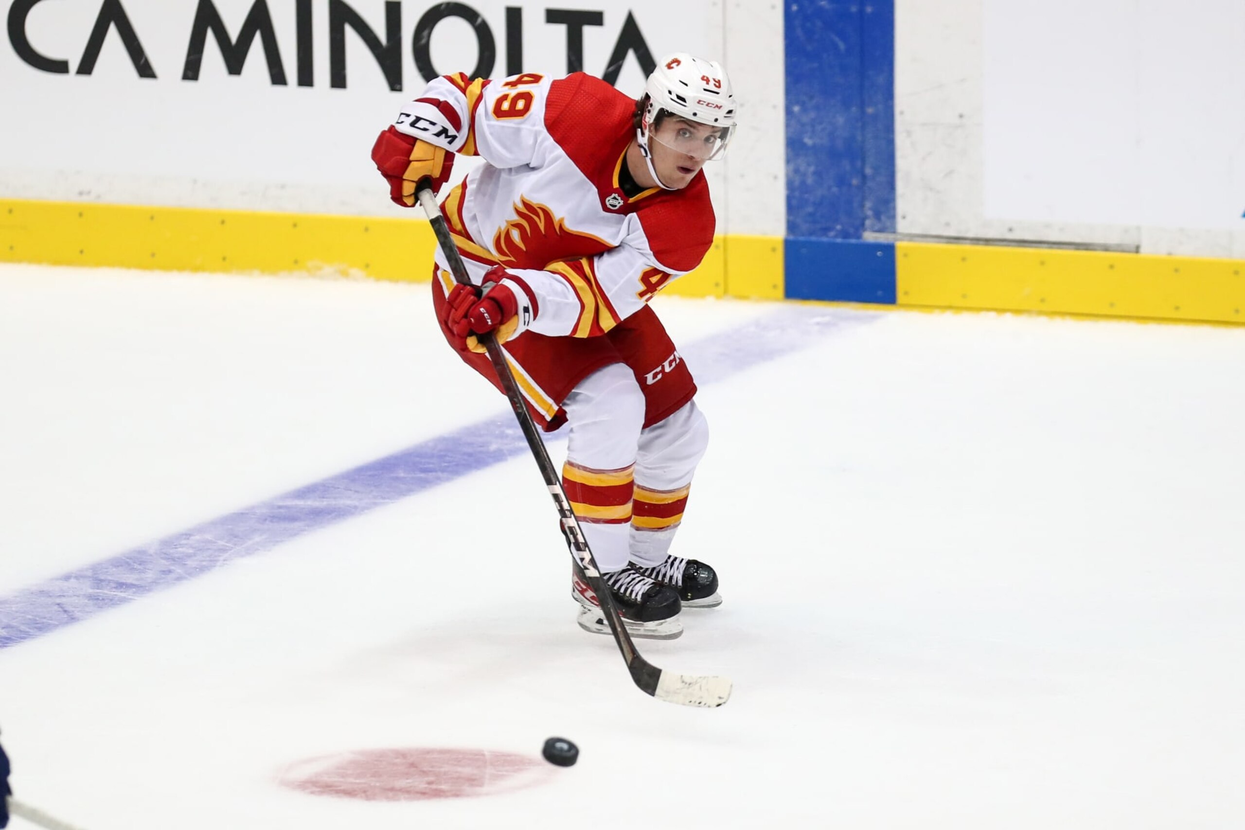 ABBOTSFORD, BC - SEPTEMBER 27: Calgary Flames Left Wing Jakob Pelletier (49) plays the puck against the Vancouver Canucks during their NHL preseason game at the Abbotsford Entertainment and Sports Centre on September 27, 2021 in Abbotsford, British Columbia, Canada. (Photo by Devin Manky/Icon Sportswire via Getty Images)