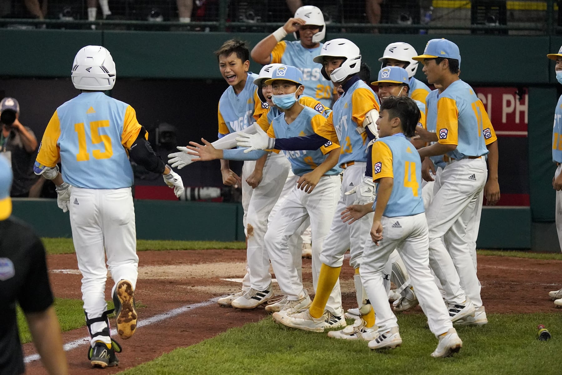 Honolulu, Hawaii's Keko Payanal (15) is greeted by teammates after hitting a two-run home run off Massapequa, N.Y.'s Danny Fregara during the fourth inning of a baseball game at the Little League World Series in South Williamsport, Pa., Friday, Aug. 19, 2022. (AP Photo/Gene J. Puskar) Honolulu, Hawaii's Keko Payanal (15) is greeted by teammates after hitting a two-run home run off Massapequa, N.Y.'s Danny Fregara during the fourth inning of a baseball game at the Little League World Series in South Williamsport, Pa., Friday, Aug. 19, 2022. (AP Photo/Gene J. Puskar)