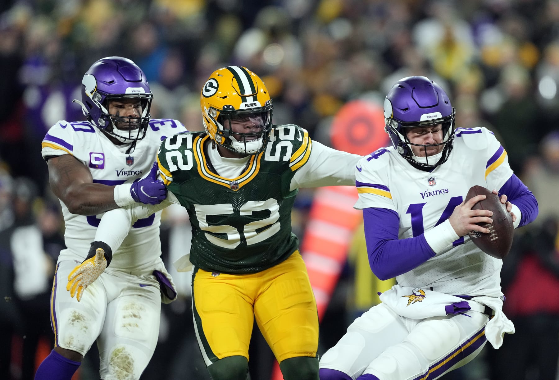 GREEN BAY, WISCONSIN - JANUARY 02:  Quarterback Sean Mannion #14 of the Minnesota Vikings is sacked by outside linebacker Rashan Gary #52 of the Green Bay Packers during the 2nd quarter of the game at Lambeau Field on January 02, 2022 in Green Bay, Wisconsin. (Photo by Patrick McDermott/Getty Images)
