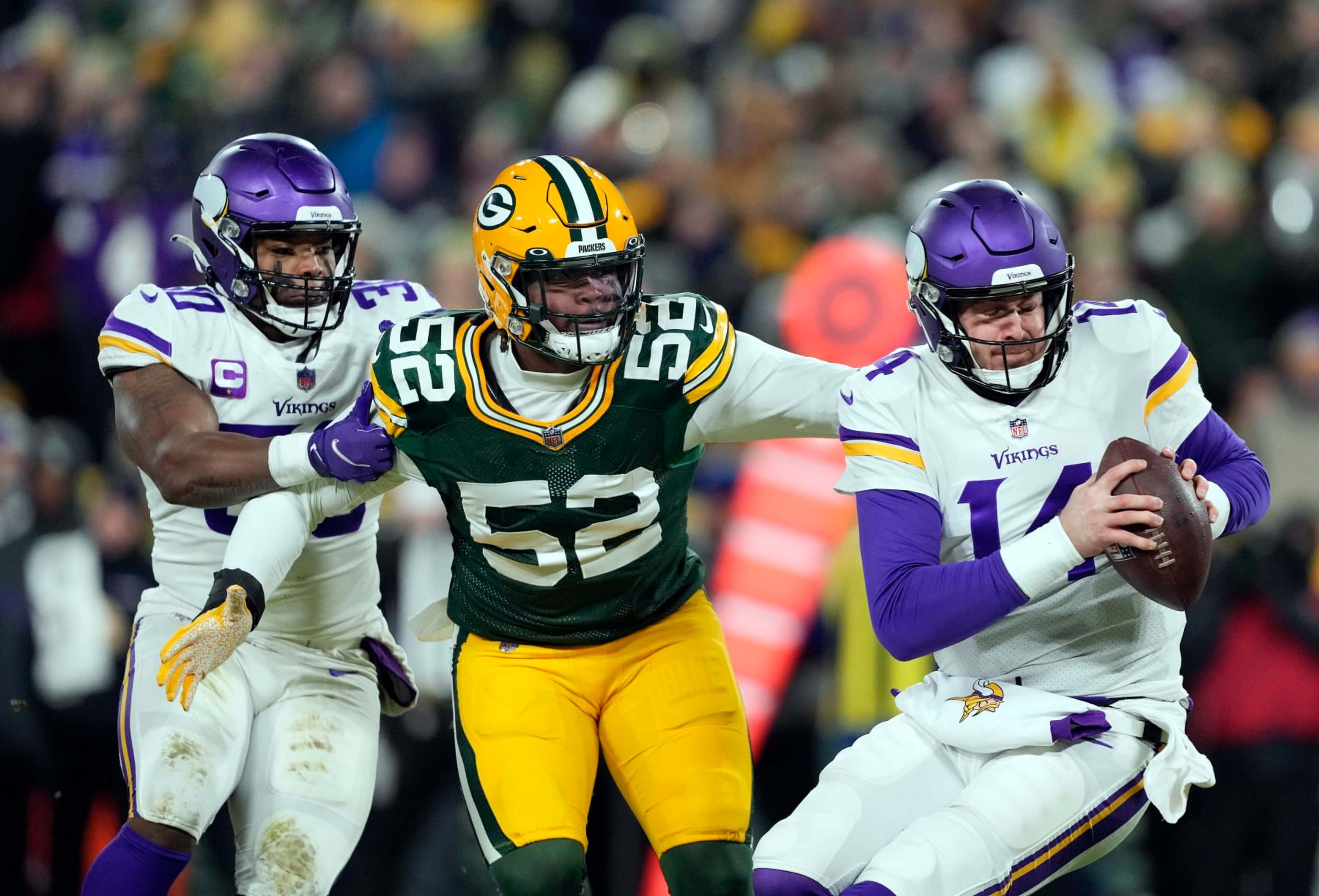 GREEN BAY, WISCONSIN - JANUARY 02:  Quarterback Sean Mannion #14 of the Minnesota Vikings is sacked by outside linebacker Rashan Gary #52 of the Green Bay Packers during the 2nd quarter of the game at Lambeau Field on January 02, 2022 in Green Bay, Wisconsin. (Photo by Patrick McDermott/Getty Images)