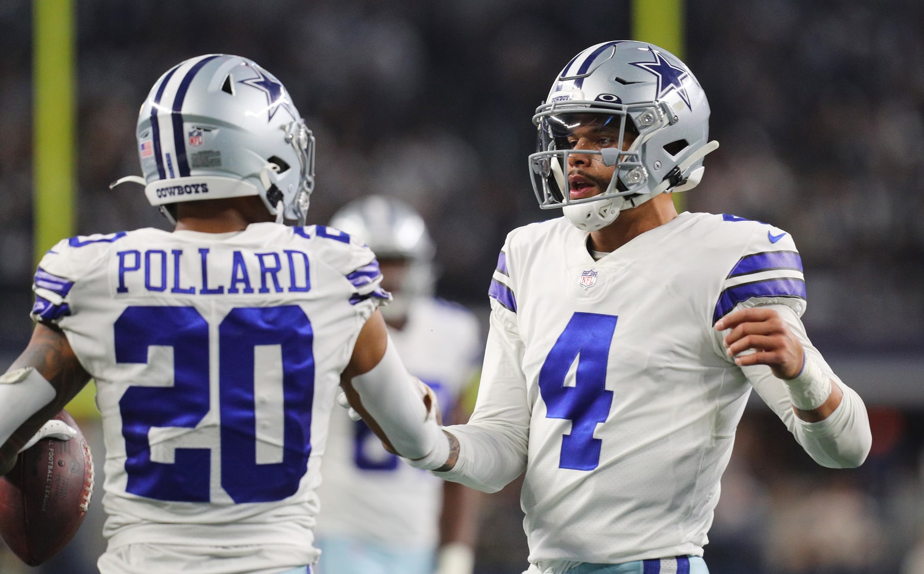 ARLINGTON, TEXAS - NOVEMBER 25: Dak Prescott #4 of the Dallas Cowboys interacts with teammate Tony Pollard #20 during the second quarter of the NFL game between Las Vegas Raiders and Dallas Cowboys at AT&T Stadium on November 25, 2021 in Arlington, Texas. (Photo by Richard Rodriguez/Getty Images)