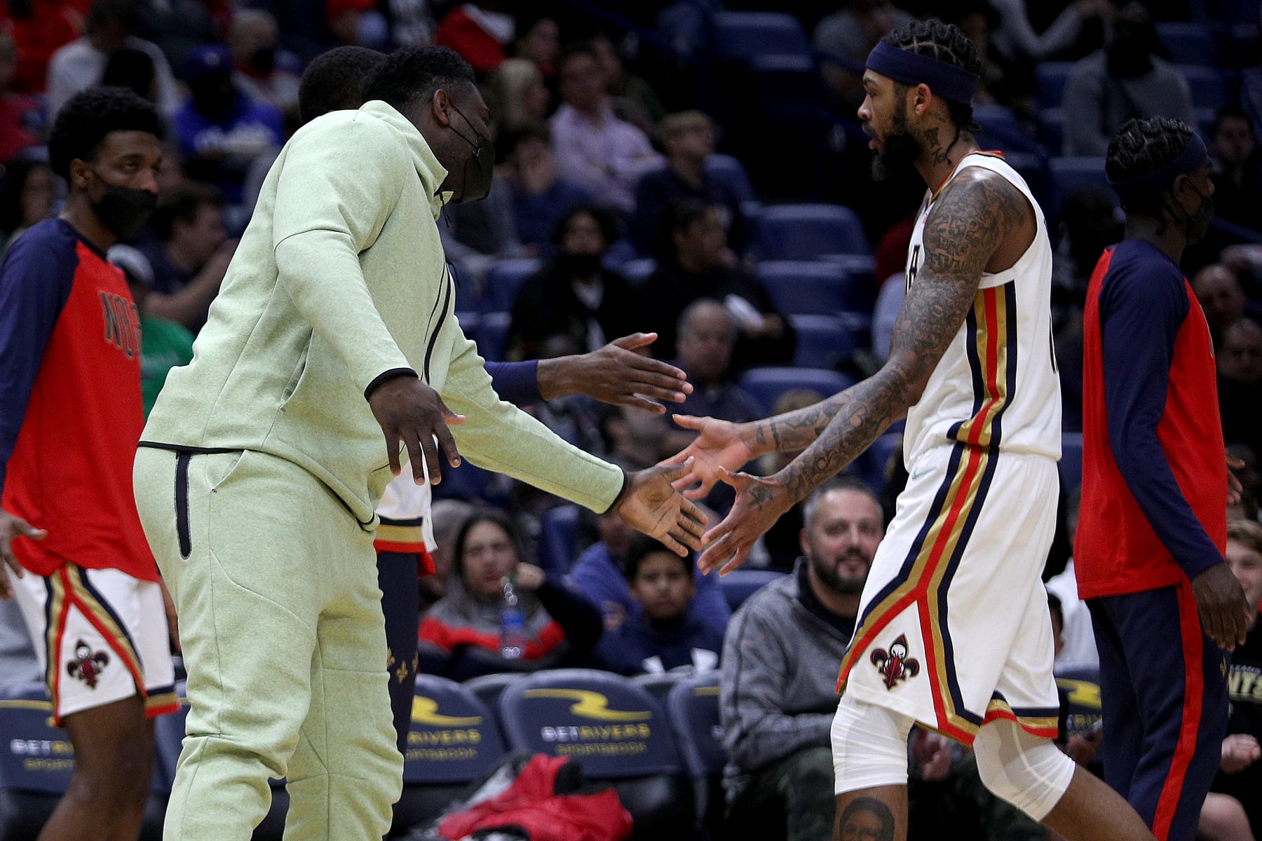 NEW ORLEANS, LOUISIANA - NOVEMBER 19: Zion Williamson #1 of the New Orleans Pelicans racts with Brandon Ingram #14 of the New Orleans Pelicans during the third quarter of a NBA game against the LA Clippers at Smoothie King Center on November 19, 2021 in New Orleans, Louisiana. NOTE TO USER: User expressly acknowledges and agrees that, by downloading and or using this photograph, User is consenting to the terms and conditions of the Getty Images License Agreement. (Photo by Sean Gardner/Getty Images)