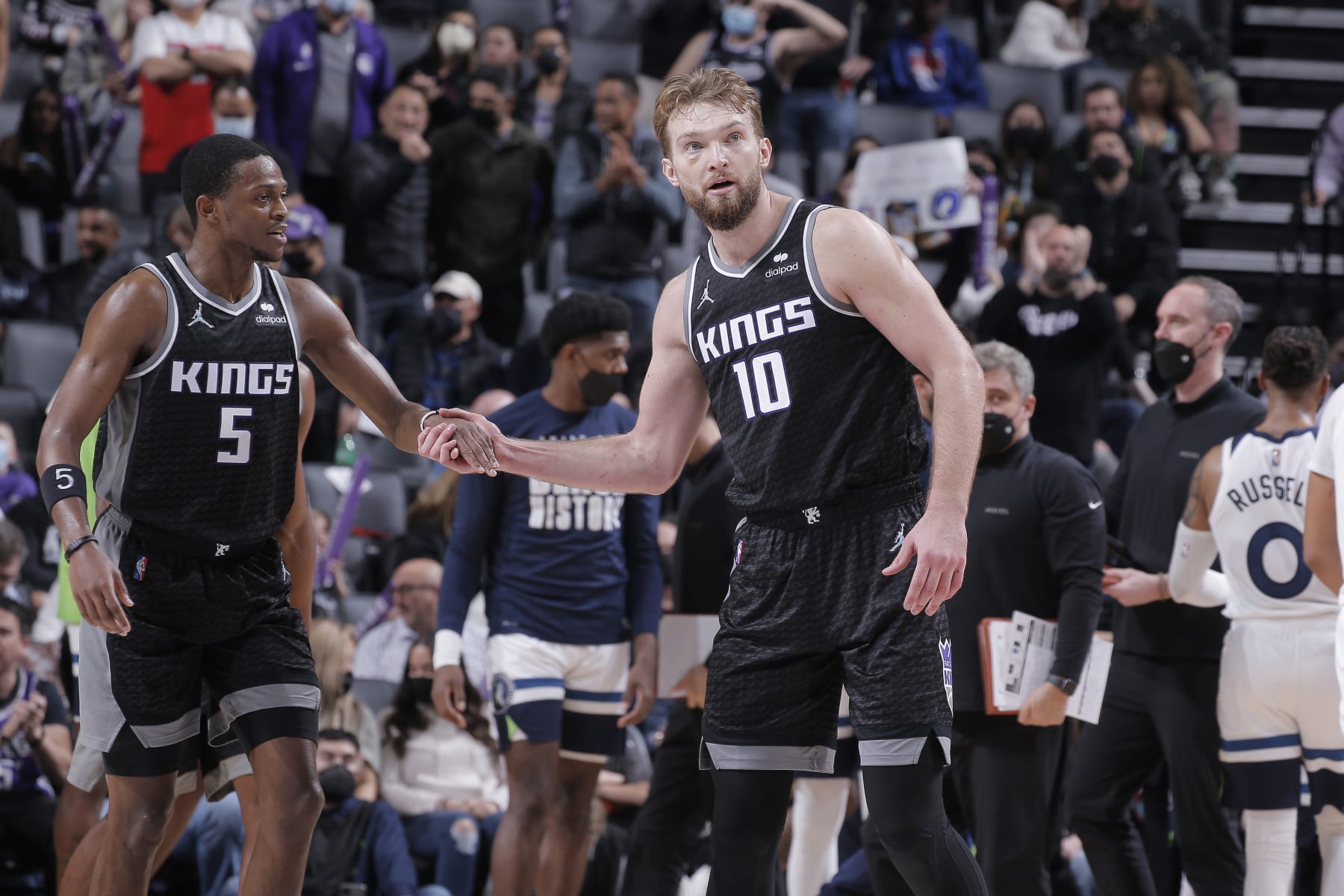 SACRAMENTO, CA - FEBRUARY 9: De'Aaron Fox #5 and Domantas Sabonis #10 of the Sacramento Kings high five during the game against the Minnesota Timberwolves on February 9, 2022 at Golden 1 Center in Sacramento, California. NOTE TO USER: User expressly acknowledges and agrees that, by downloading and or using this photograph, User is consenting to the terms and conditions of the Getty Images Agreement. Mandatory Copyright Notice: Copyright 2022 NBAE (Photo by Rocky Widner/NBAE via Getty Images)