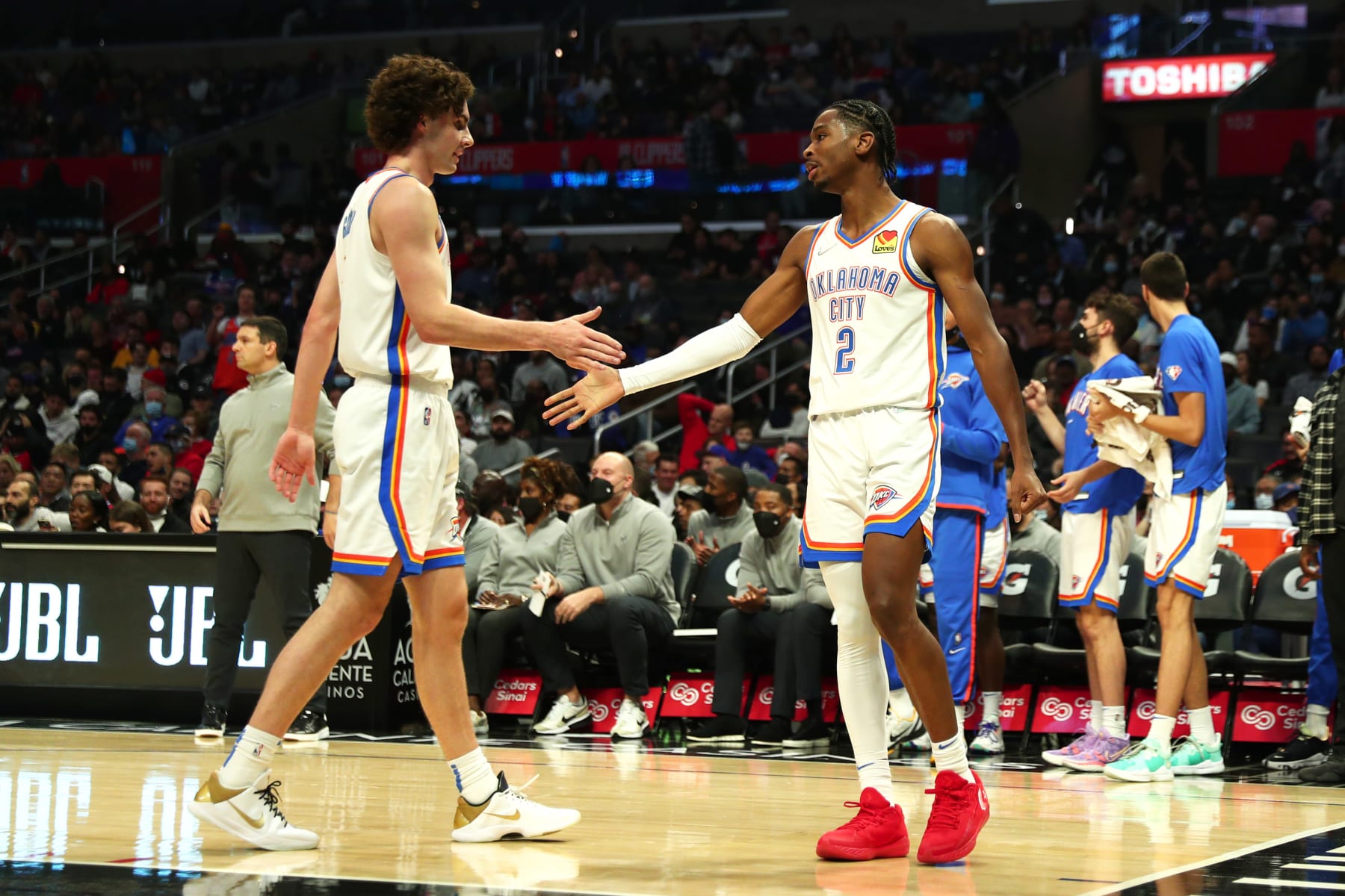 LOS ANGELES, CA - NOVEMBER 1: Shai Gilgeous-Alexander #2 and Josh Giddey #3 of the Oklahoma City Thunder shake hands during the game against the LA Clippers on November 1, 2021 at STAPLES Center in Los Angeles, California. NOTE TO USER: User expressly acknowledges and agrees that, by downloading and/or using this Photograph, user is consenting to the terms and conditions of the Getty Images License Agreement. Mandatory Copyright Notice: Copyright 2021 NBAE (Photo by Zach Beeker/NBAE via Getty Images)