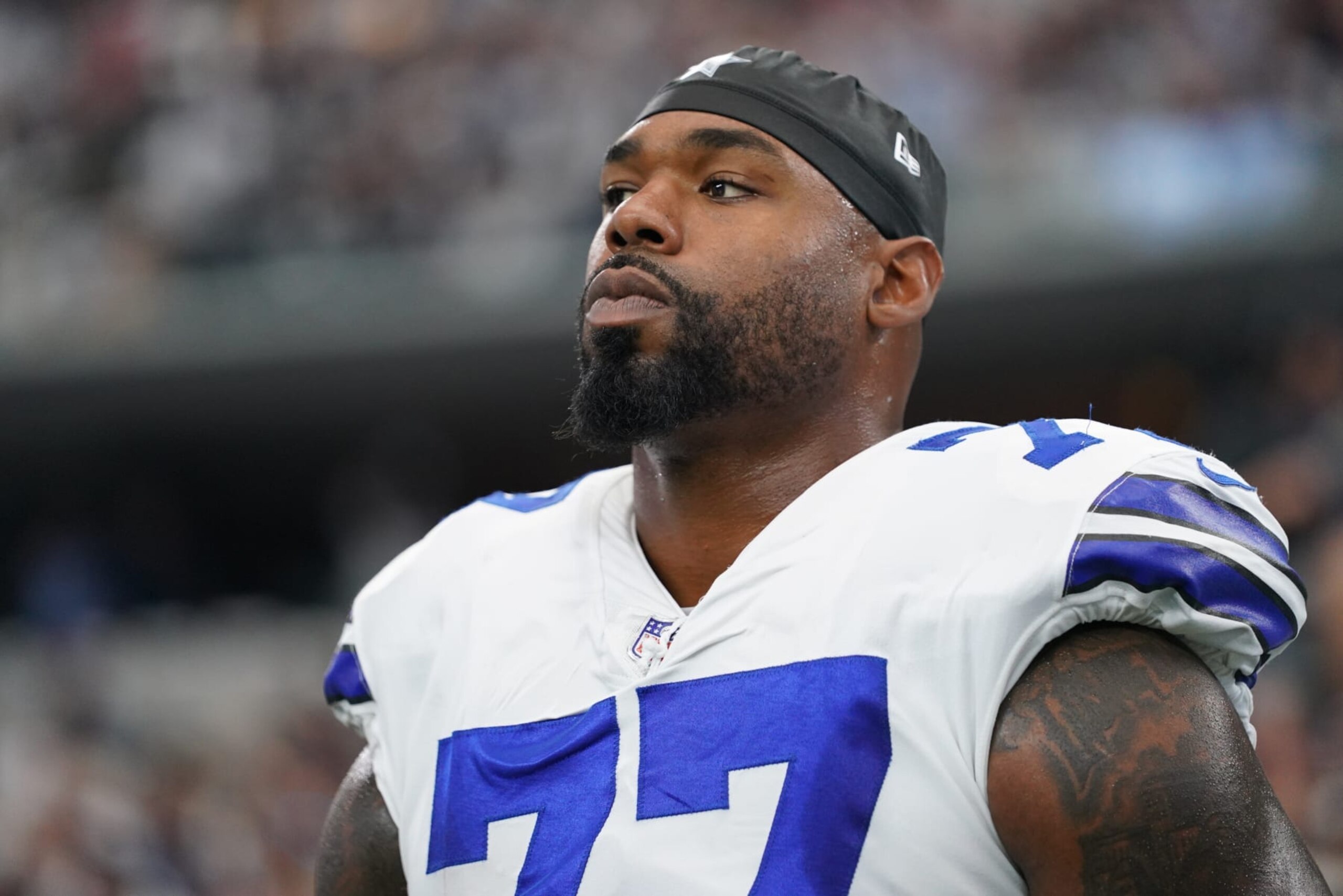ARLINGTON, TEXAS - OCTOBER 10: Tyron Smith #77 of the Dallas Cowboys looks toward the field during the national anthem against the New York Giants prior to an NFL game at AT&T Stadium on October 10, 2021 in Arlington, Texas. (Photo by Cooper Neill/Getty Images)
