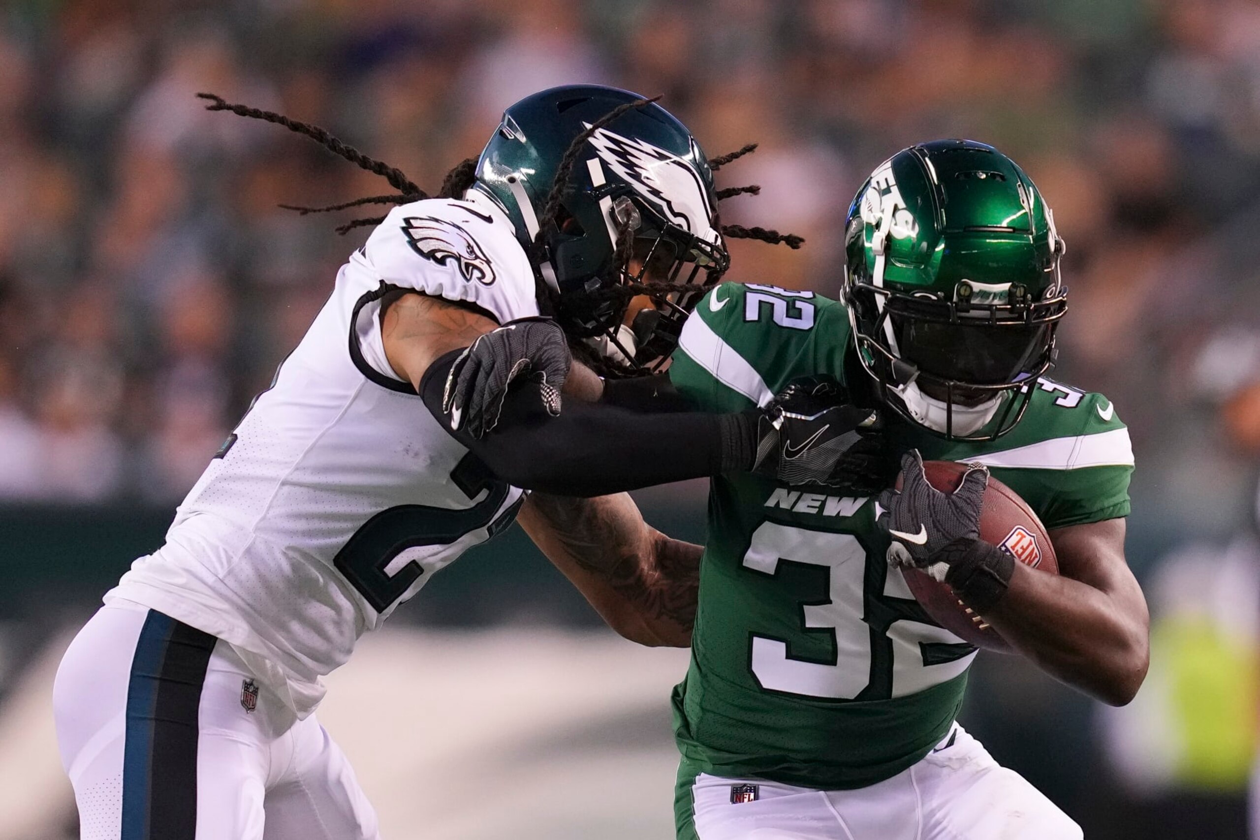 PHILADELPHIA, PA - AUGUST 12: Michael Carter #32 of the New York Jets runs the ball and is pushed out of bounds by Andre Chachere #21 of the Philadelphia Eagles in the first half of the preseason game at Lincoln Financial Field on August 12, 2022 in Philadelphia, Pennsylvania. (Photo by Mitchell Leff/Getty Images)
