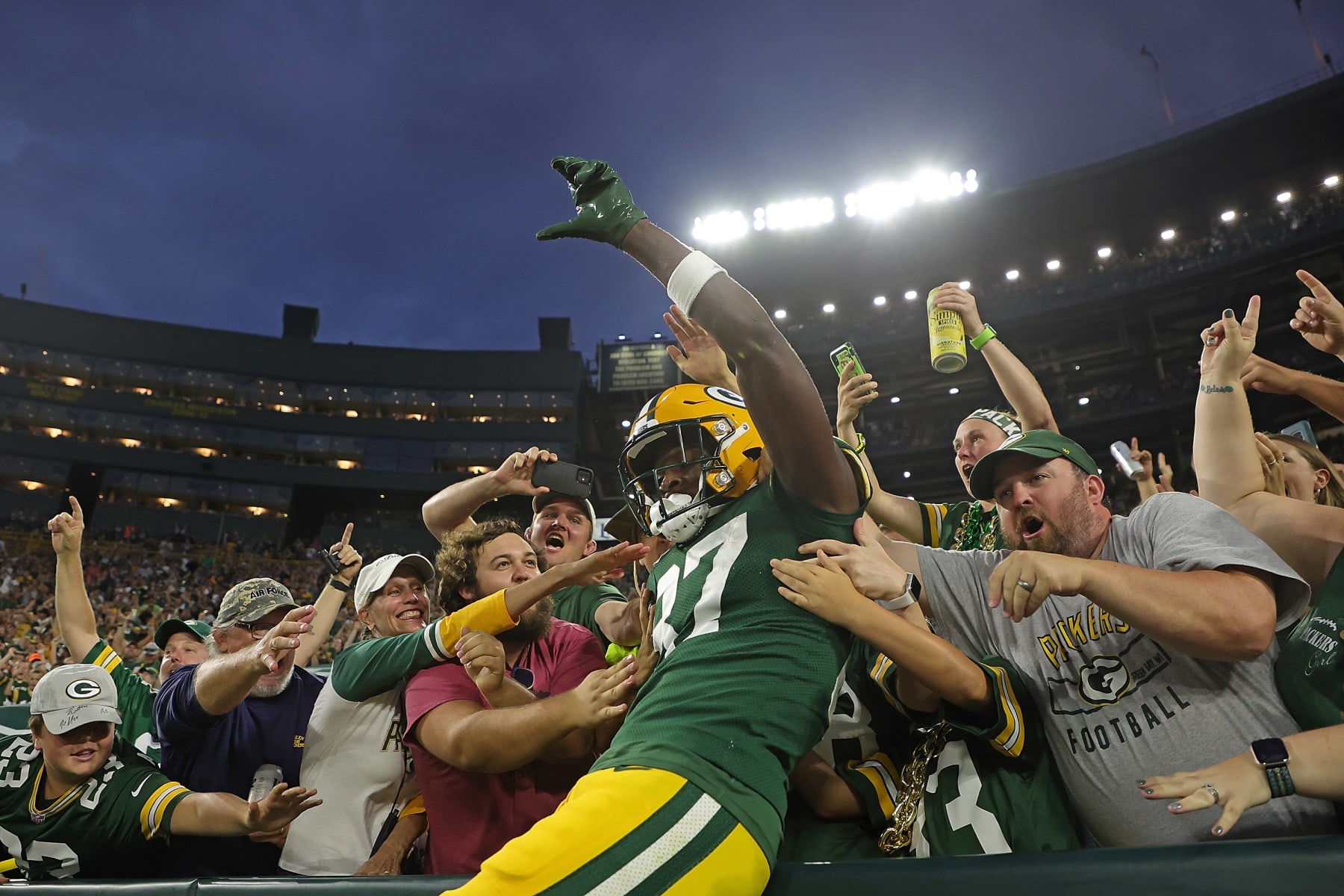 GREEN BAY, WISCONSIN - AUGUST 19: Romeo Doubs #87 of the Green Bay Packers leaps into the stands following a touchdown reception against the New Orleans Saints during the first half of a preseason game at Lambeau Field on August 19, 2022 in Green Bay, Wisconsin. (Photo by Stacy Revere/Getty Images)