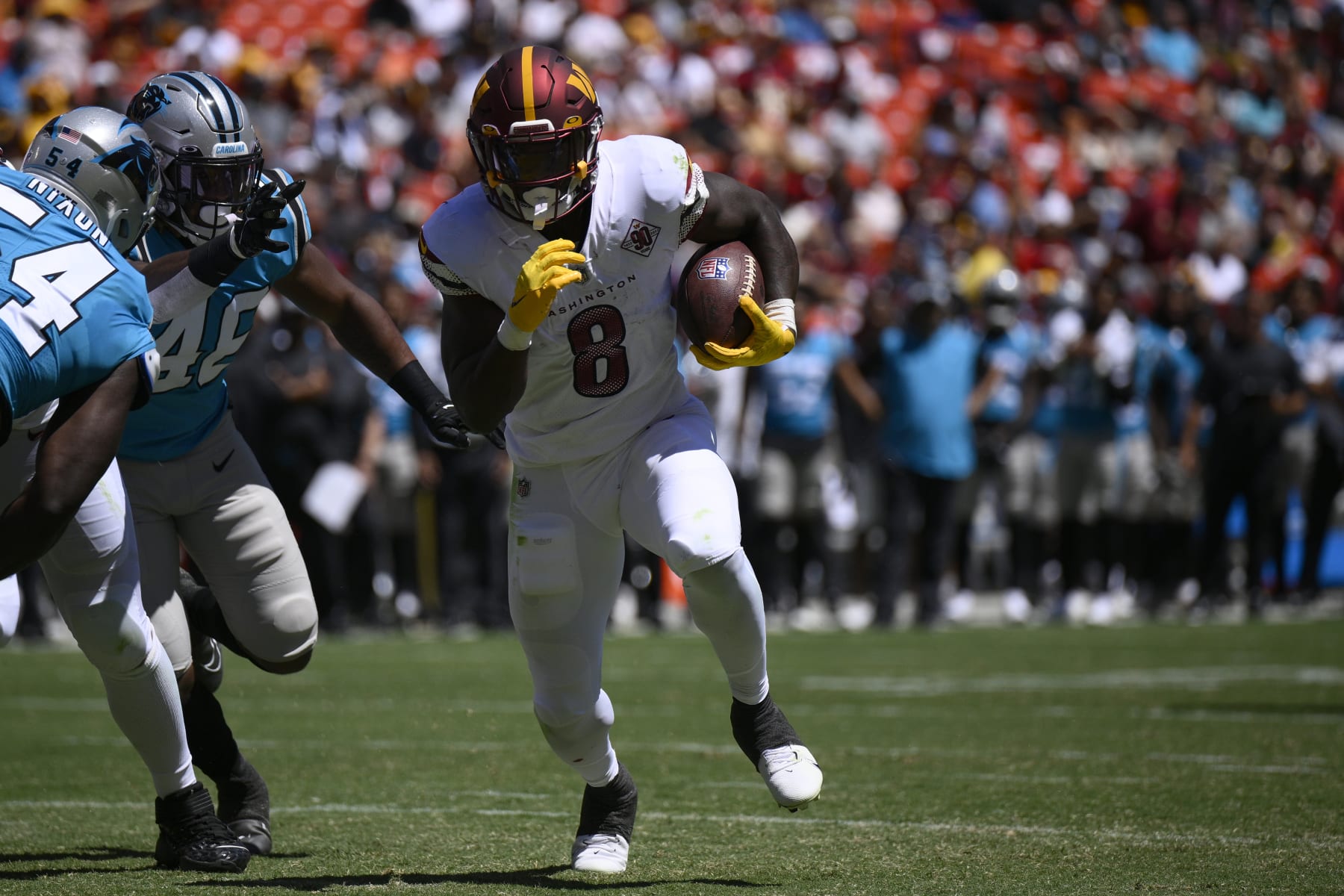 Washington Commanders running back Brian Robinson (8) runs with the ball during the first half of a preseason NFL football game against the Carolina Panthers, Saturday, Aug. 13, 2022, in Landover, Md. (AP Photo/Nick Wass)