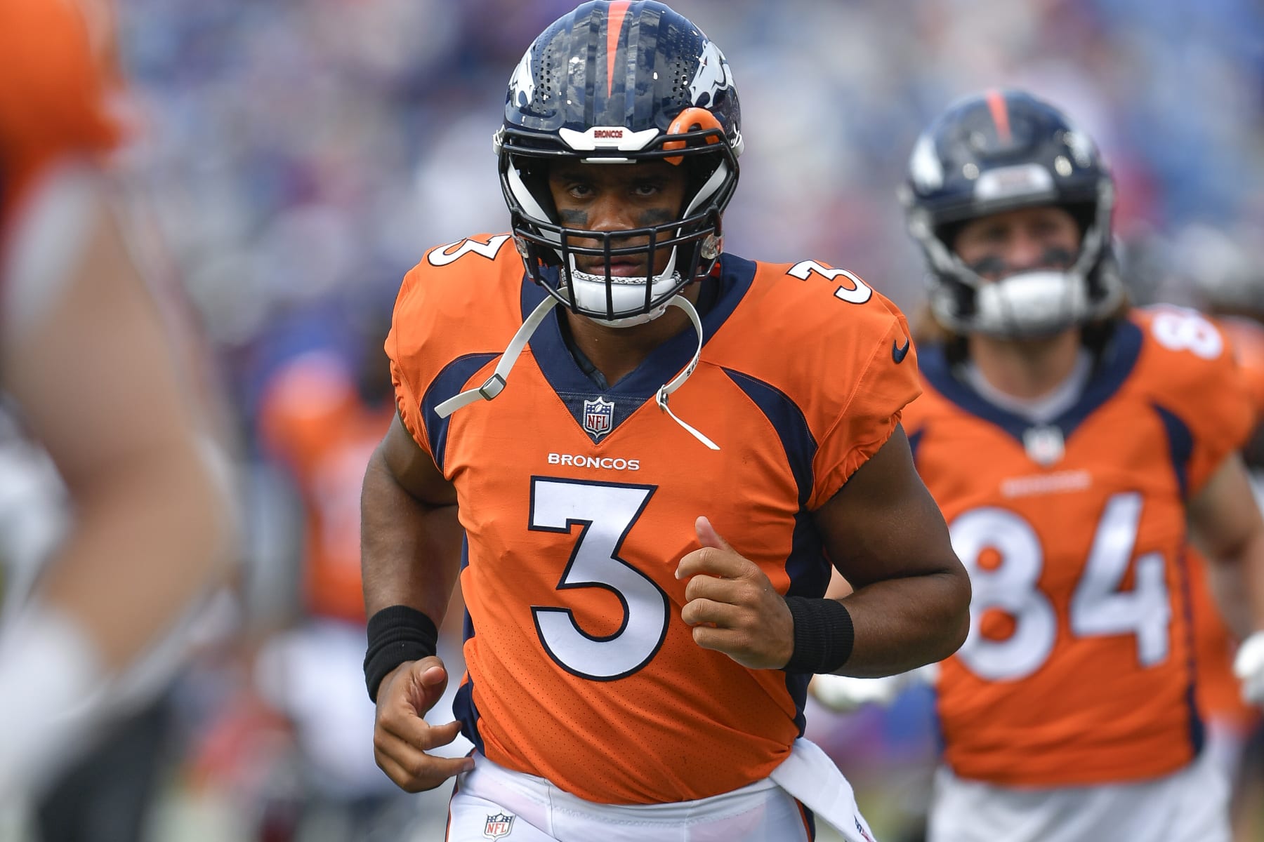Denver Broncos quarterback Russell Wilson runs on the field during the first half of a preseason NFL football game against the Buffalo Bills in Orchard Park, N.Y., Saturday, Aug. 20, 2022. (AP Photo/Adrian Kraus)