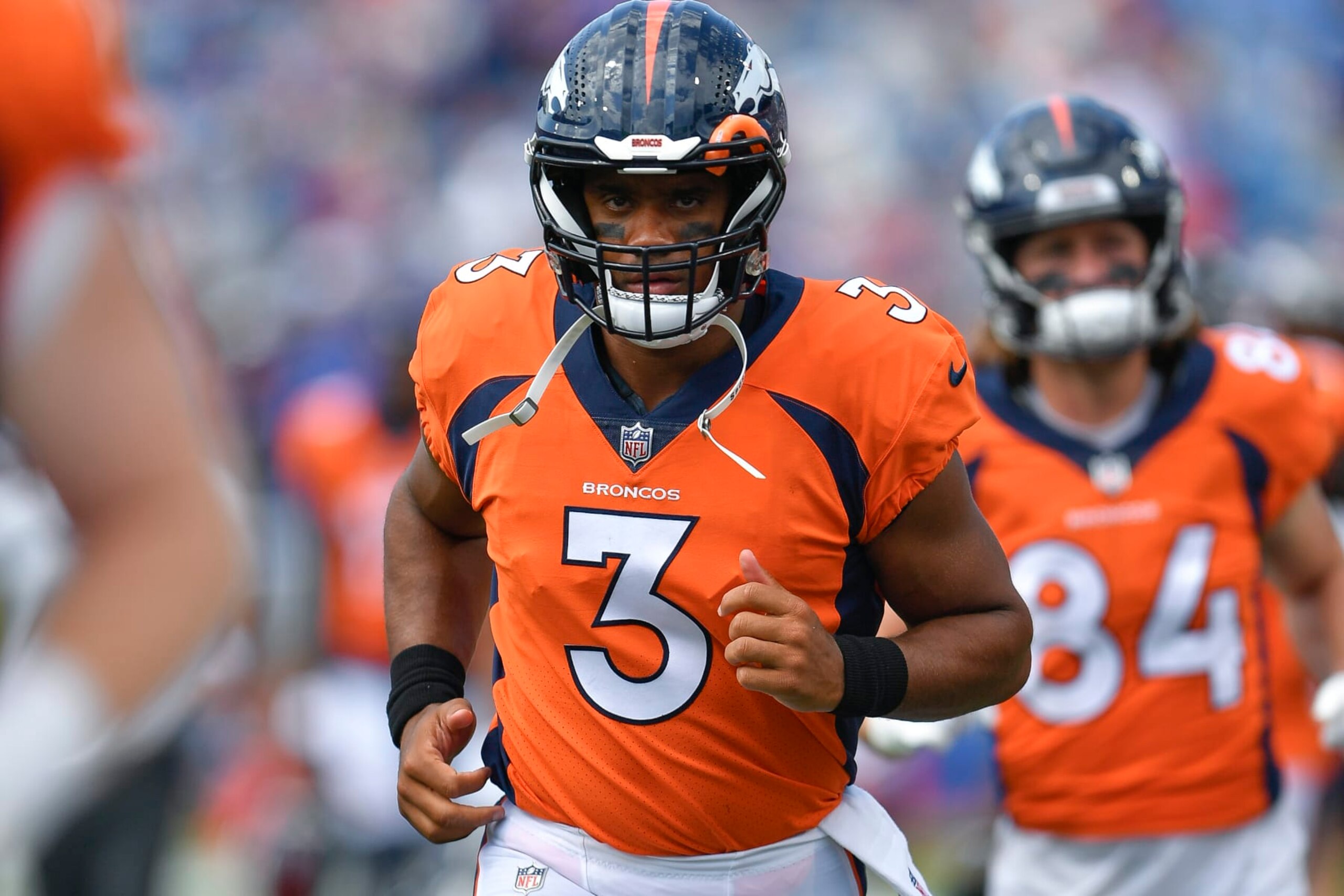 Denver Broncos quarterback Russell Wilson runs on the field during the first half of a preseason NFL football game against the Buffalo Bills in Orchard Park, N.Y., Saturday, Aug. 20, 2022. (AP Photo/Adrian Kraus)