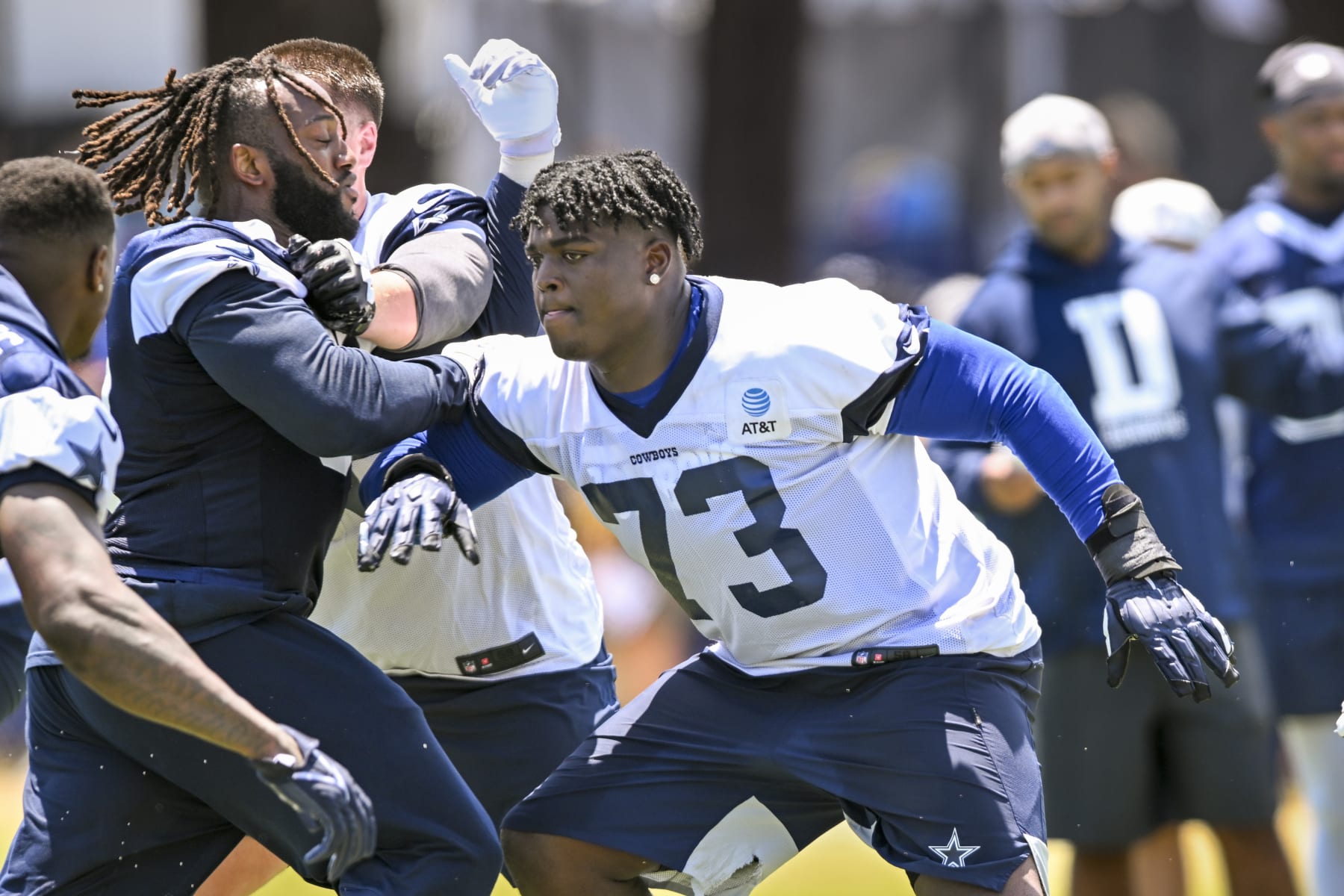 Dallas Cowboys defensive tackle Osa Odighizuwa, left, rushes offensive tackle Tyler Smith (73) as they run a play during NFL football training camp, Wednesday, July 27, 2022, in Oxnard, Calif. (AP Photo/Gus Ruelas)