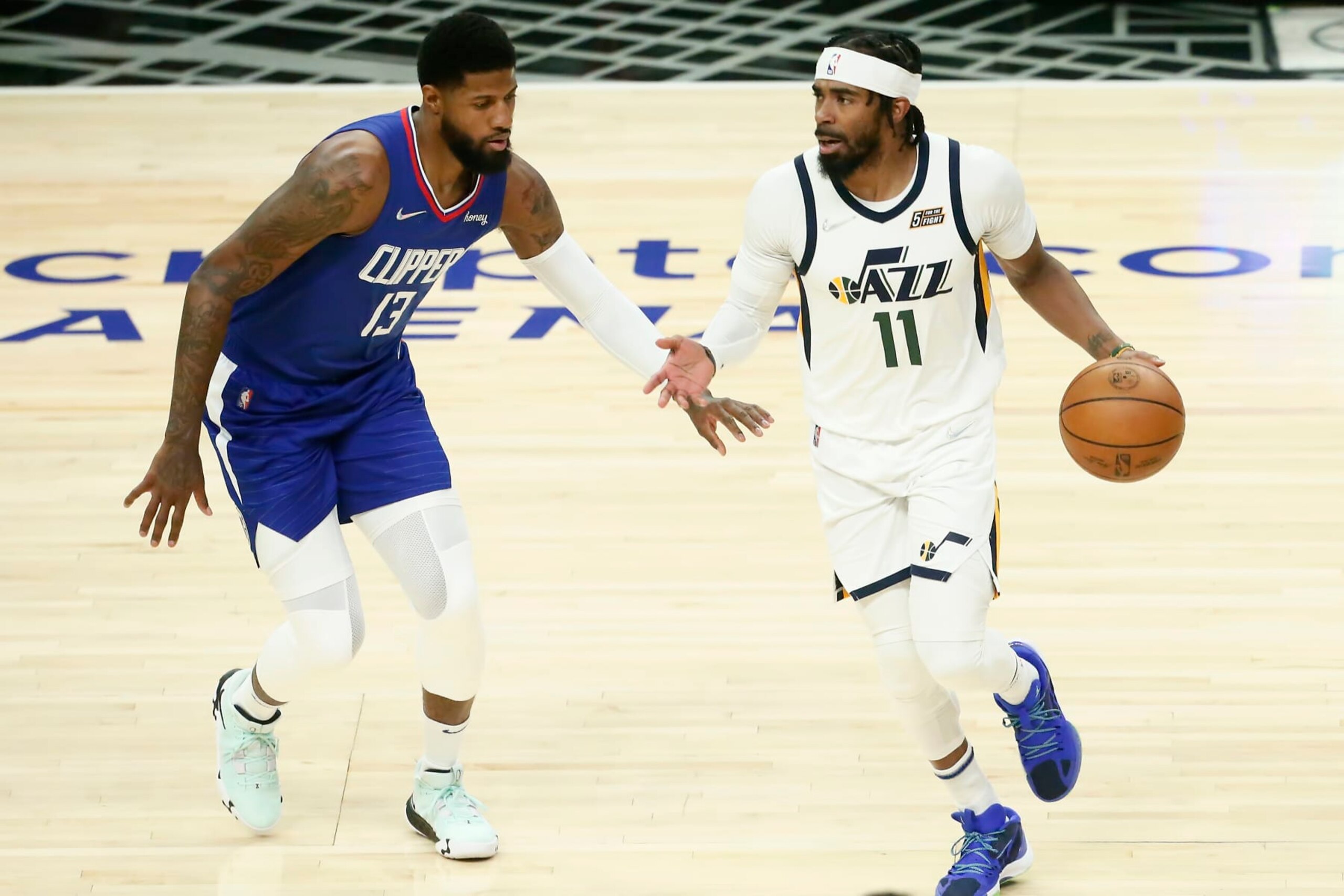 LOS ANGELES, CA - MARCH 29: Paul George #13 of the LA Clippers defends on Mike Conley #11 of the Utah Jazz during a game at the Crypto.com Arena on March 29, 2022 in Los Angeles, California. NOTE TO USER: User expressly acknowledges and agrees that, by downloading and or using this photograph, User is consenting to the terms and conditions of the Getty Images License Agreement. Mandatory Credit: 2022 NBAE (Photo by Chris Elise/NBAE via Getty Images) LOS ANGELES, CA - MARCH 29: Paul George #13 of the LA Clippers defends on Mike Conley #11 of the Utah Jazz during a game at the Crypto.com Arena on March 29, 2022 in Los Angeles, California. NOTE TO USER: User expressly acknowledges and agrees that, by downloading and or using this photograph, User is consenting to the terms and conditions of the Getty Images License Agreement. Mandatory Credit: 2022 NBAE (Photo by Chris Elise/NBAE via Getty Images)