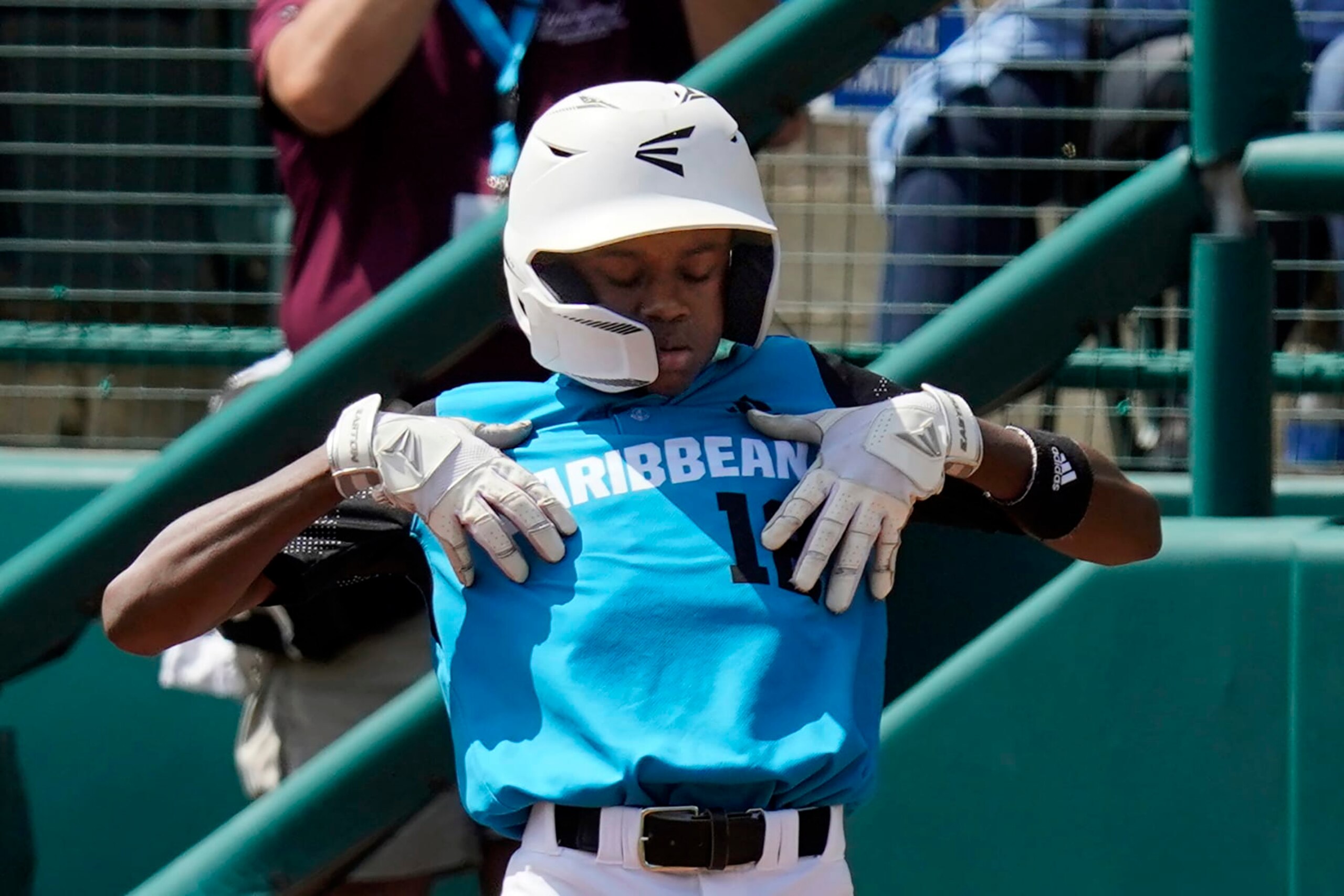 Curacao's Jaydion Louisa celebrates on first base after driving in a run during the third inning of the International Championship baseball game against Taiwan at the Little League World Series tournament in South Williamsport, Pa., Saturday, Aug. 27, 2022. (AP Photo/Gene J. Puskar)