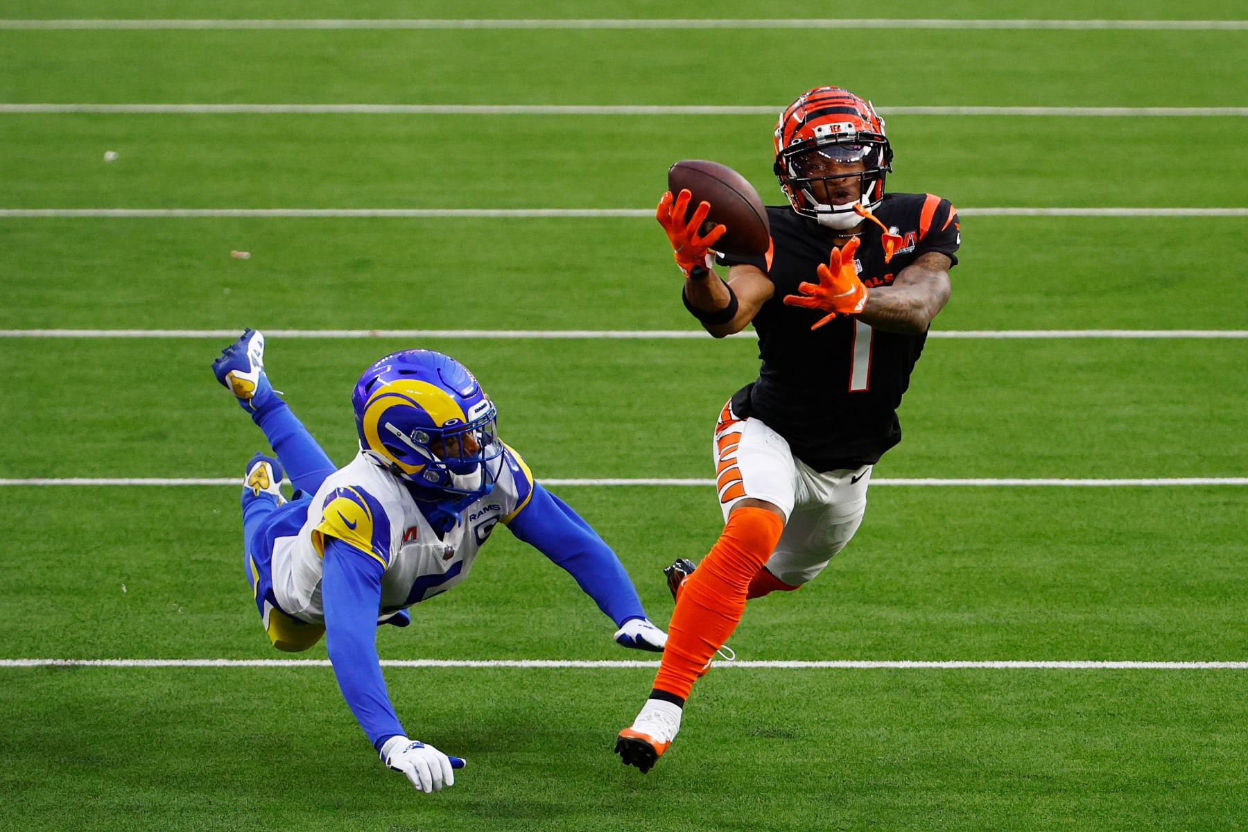 INGLEWOOD, CALIFORNIA - FEBRUARY 13: Ja'Marr Chase #1 of the Cincinnati Bengals makes a catch over Jalen Ramsey #5 of the Los Angeles Rams during Super Bowl LVI at SoFi Stadium on February 13, 2022 in Inglewood, California. (Photo by Ronald Martinez/Getty Images)