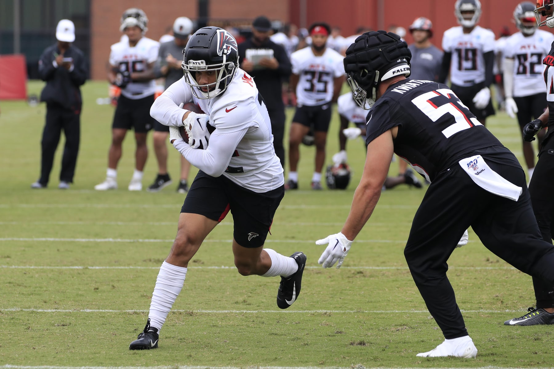 FLOWERY BRANCH, GA - JULY 30: Atlanta Falcons wide receiver Khadarel Hodge (12) tries to evade Atlanta Falcons inside linebacker Nick Kwiatkoski (53) during Saturday morning workouts for the Atlanta Falcons on July, 30, 2022 at the Atlanta Falcons Training Facility in Flowery Branch, Georgia.  (Photo by David J. Griffin/Icon Sportswire via Getty Images)