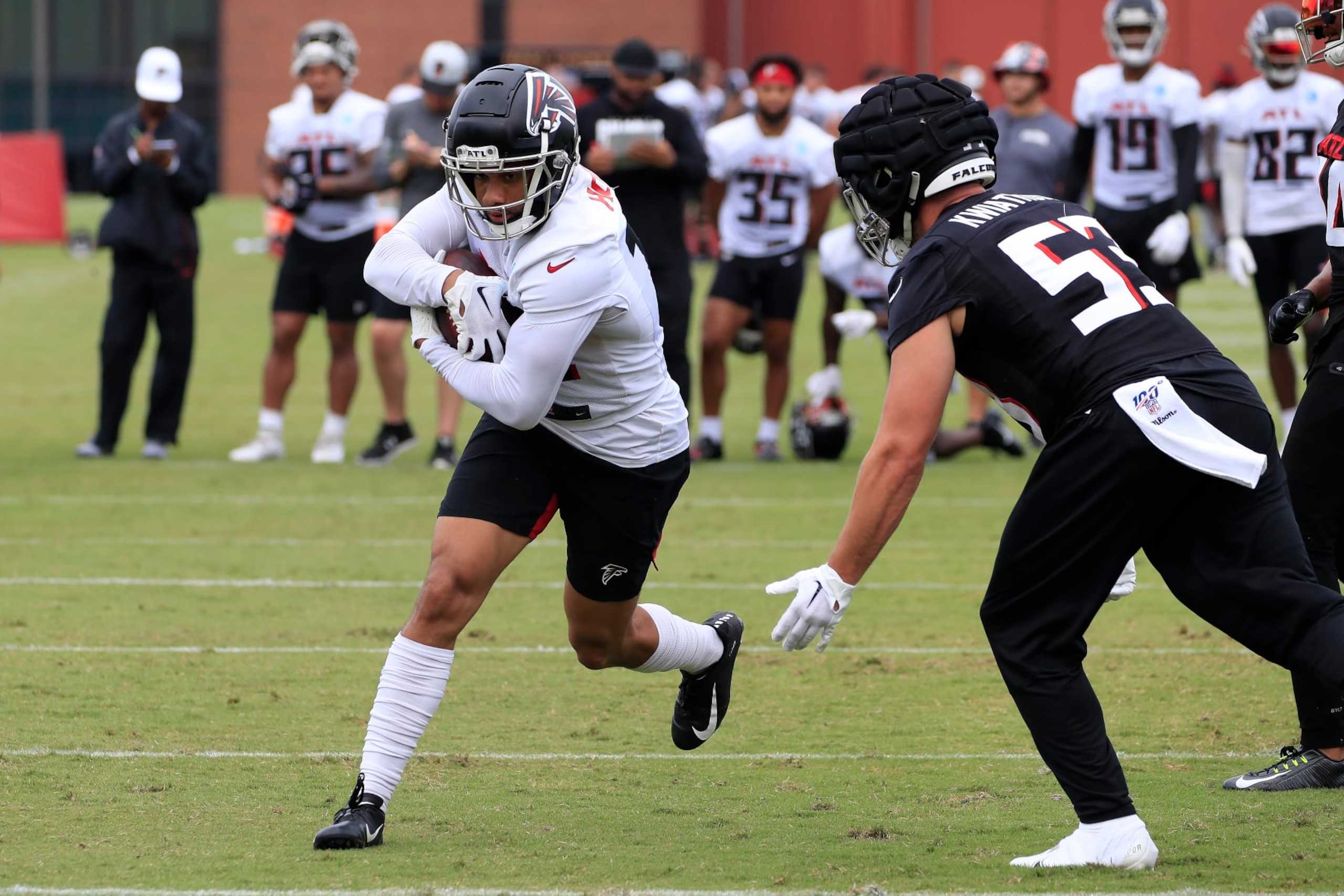 FLOWERY BRANCH, GA - JULY 30: Atlanta Falcons wide receiver Khadarel Hodge (12) tries to evade Atlanta Falcons inside linebacker Nick Kwiatkoski (53) during Saturday morning workouts for the Atlanta Falcons on July, 30, 2022 at the Atlanta Falcons Training Facility in Flowery Branch, Georgia.  (Photo by David J. Griffin/Icon Sportswire via Getty Images)