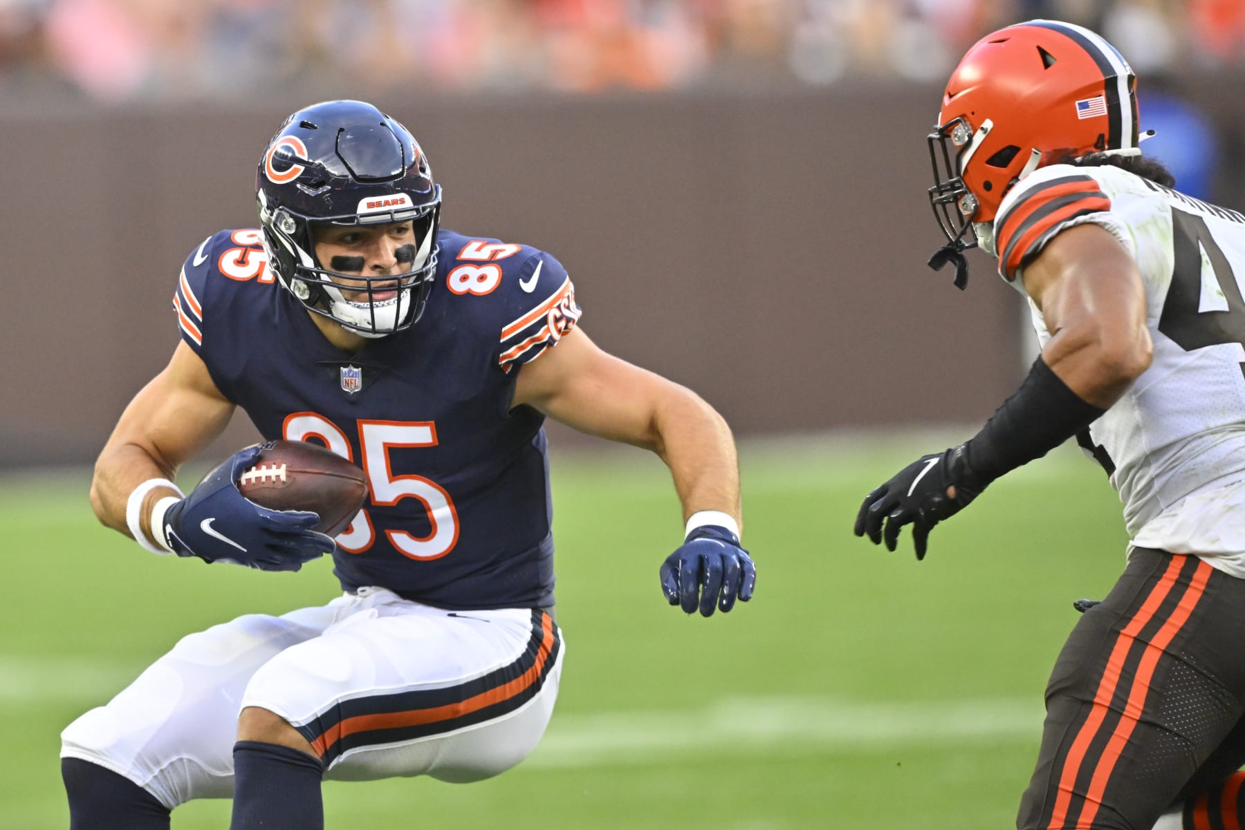 Chicago Bears tight end Cole Kmet (85) tries to evade Cleveland Browns linebacker Sione Takitaki (44) as he runs in the first half of an NFL preseason football game, Saturday, Aug. 27, 2022, in Cleveland. (AP Photo/David Richard)