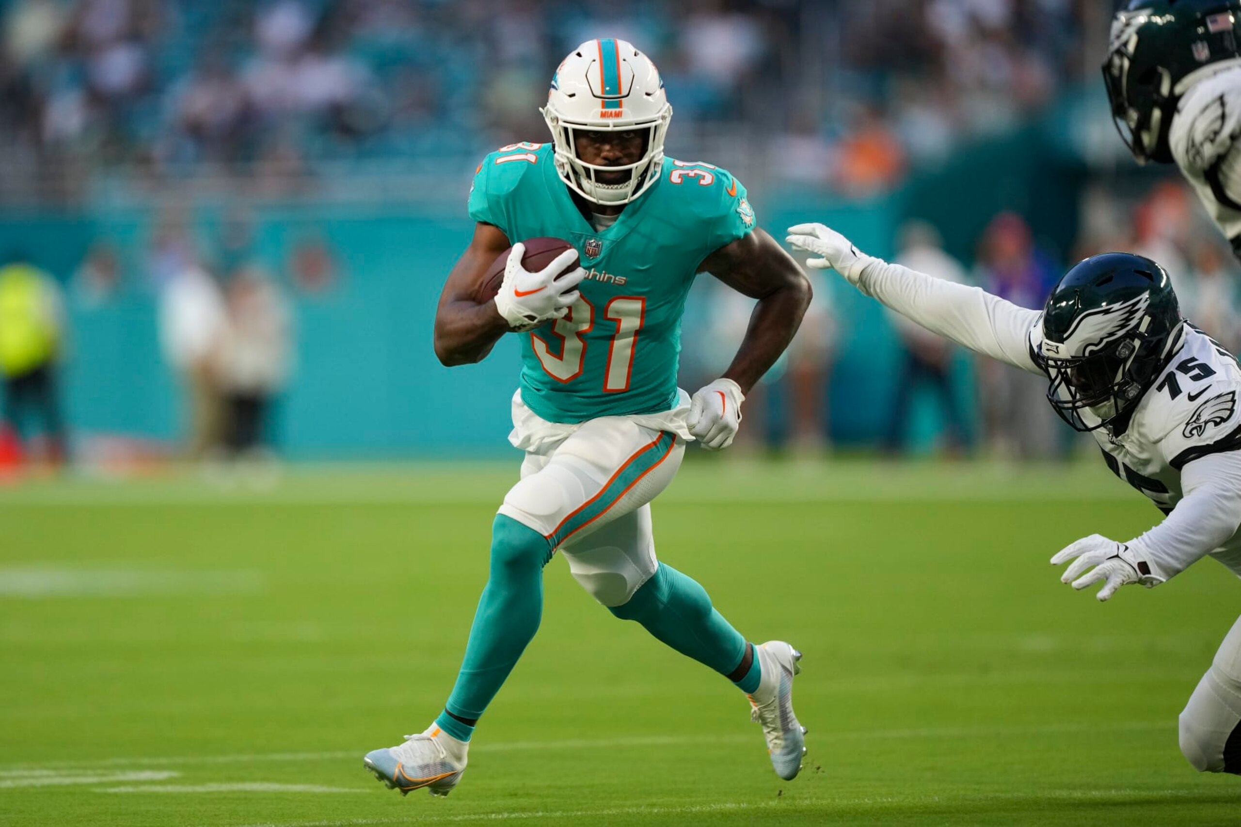 MIAMI GARDENS, FLORIDA - AUGUST 27: Raheem Mostert #31 of the Miami Dolphins rushes the football during the first quarter of the preseason game against the Philadelphia Eagles at Hard Rock Stadium on August 27, 2022 in Miami Gardens, Florida. (Photo by Eric Espada/Getty Images)