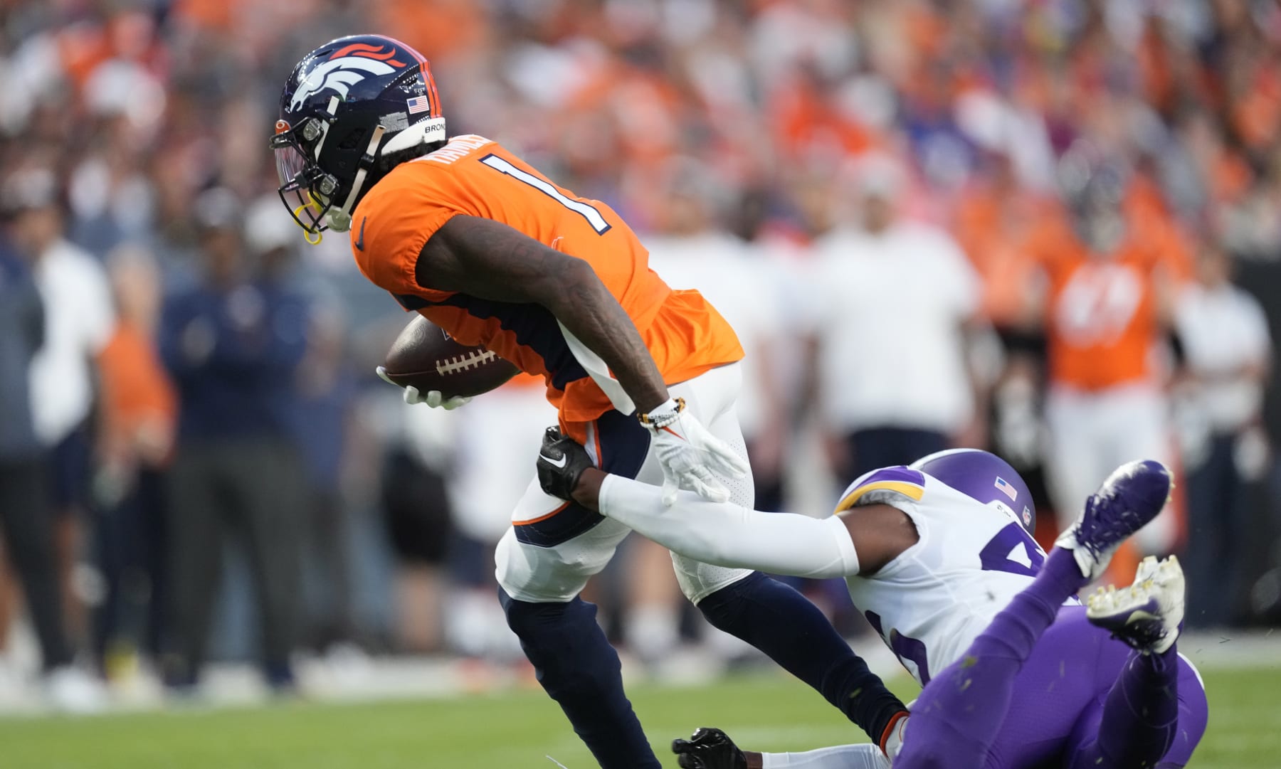 Denver Broncos wide receiver KJ Hamler (1) is tackled by Minnesota Vikings safety Myles Dorn (46) during an NFL preseason football game, Aug. 27, 2022, in Denver. (AP Photo/David Zalubowski)