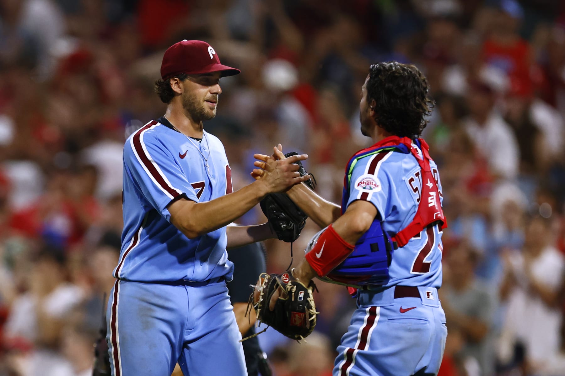 PHILADELPHIA, PA - AUGUST 25: Pitcher Aaron Nola #27 of the Philadelphia Phillies is congratulated by catcher Garrett Stubbs #21 after getting the final out for a complete game five hit shutout in a game against the Cincinnati Reds at Citizens Bank Park on August 25, 2022 in Philadelphia, Pennsylvania. The Phillies defeated the Reds 4-0. (Photo by Rich Schultz/Getty Images)