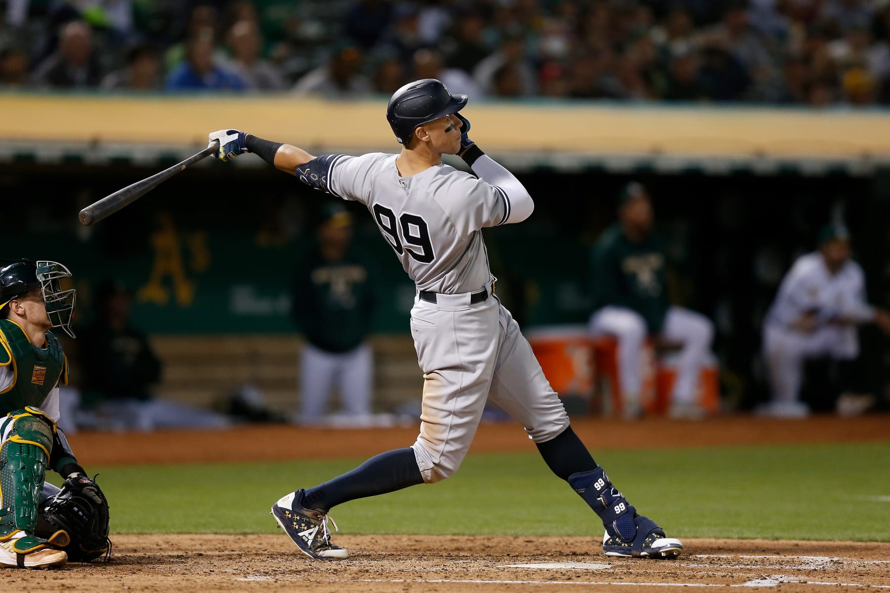 OAKLAND, CALIFORNIA - AUGUST 26: Aaron Judge #99 of the New York Yankees hits a three-run home run in the top of the fifth inning against the Oakland Athletics at RingCentral Coliseum on August 26, 2022 in Oakland, California. (Photo by Lachlan Cunningham/Getty Images)