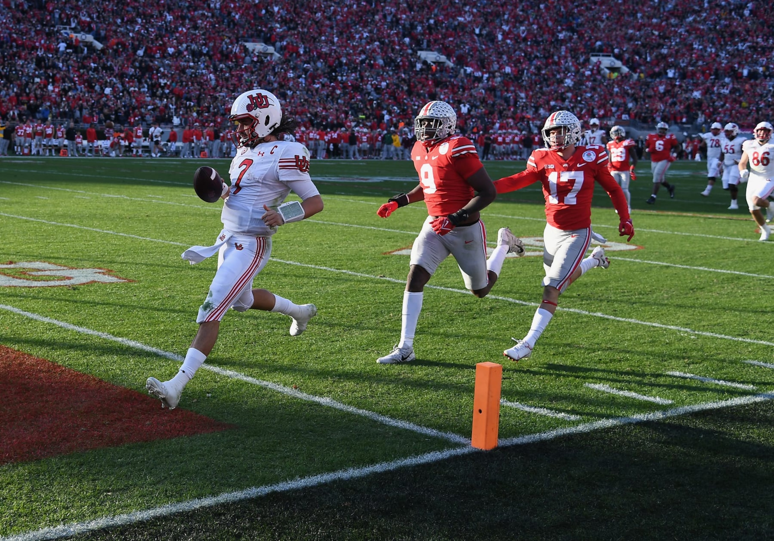 PASADENA, CA - JANUARY 01: Utah Utes quarterback Cameron Rising (7) runs into the end zone for a touchdown ahead of Ohio State Buckeyes defensive end Zach Harrison (9) and safety Bryson Shaw (17) during the first half of the Rose Bowl game played on January 1, 2022 at the Rose Bowl in Pasadena CA. (Photo by John Cordes/Icon Sportswire via Getty Images)