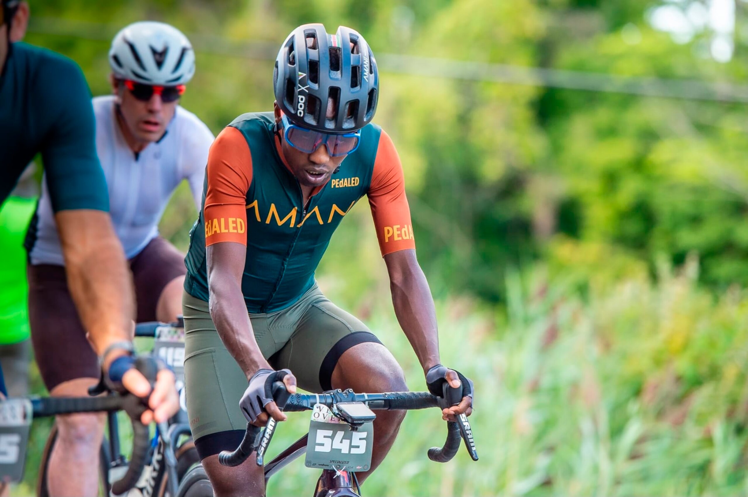 In this photo provided by Joseph Viger, Kenyan cyclist Sule Kangangi cycles at a gravel race in Vermont, Saturday, Aug. 27, 2022. Kangangi died in a crash later in the day, while competing in the race. (Joseph Viger via AP)