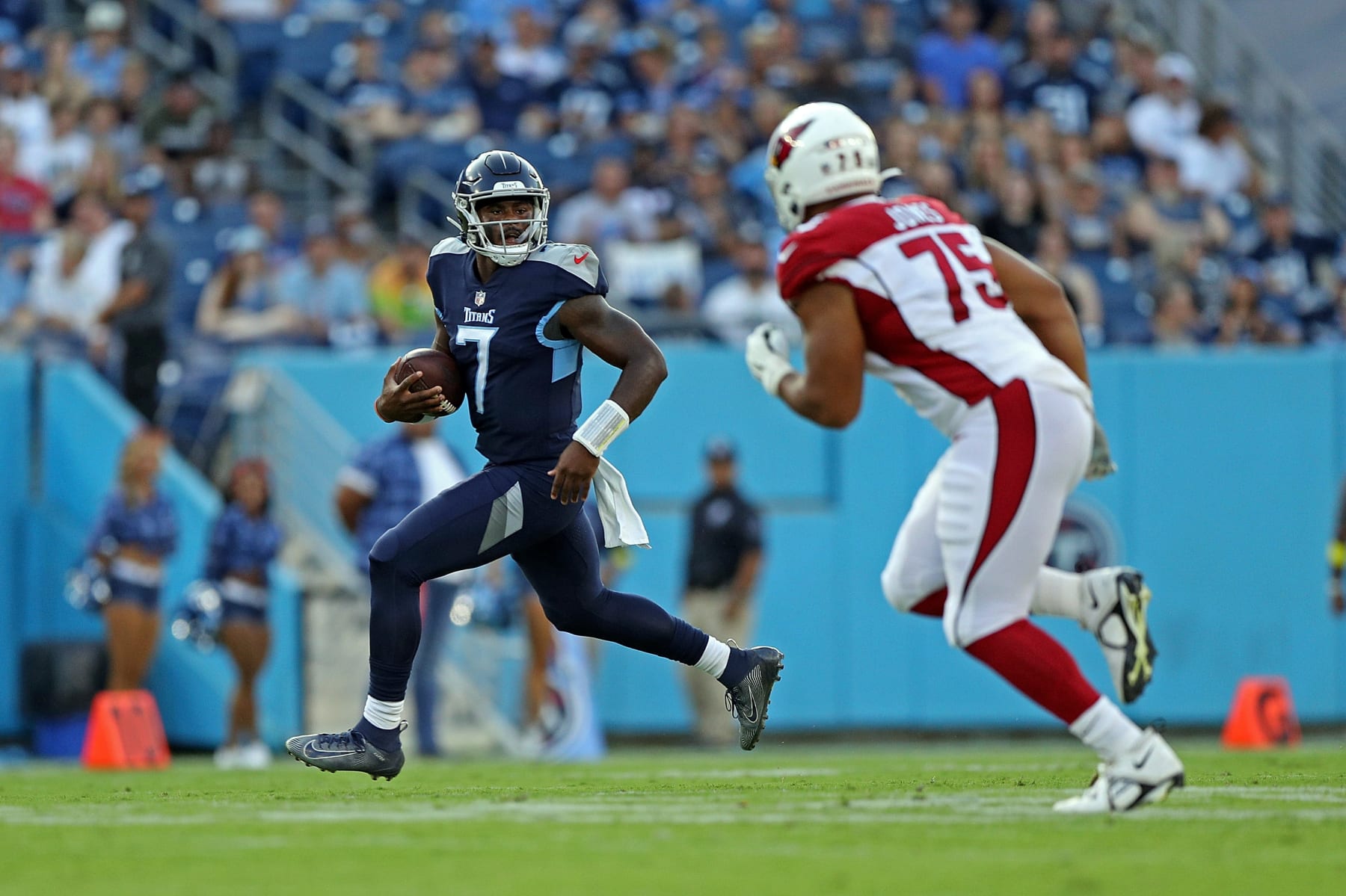 NASHVILLE, TENNESSEE - AUGUST 27: Malik Willis #7 of the Tennessee Titans carries the ball against Manny Jones #75 of the Arizona Cardinals during the preseason game at Nissan Stadium on August 27, 2022 in Nashville, Tennessee. The Titans defeated the Cardinals 26-23. (Photo by Justin Ford/Getty Images)