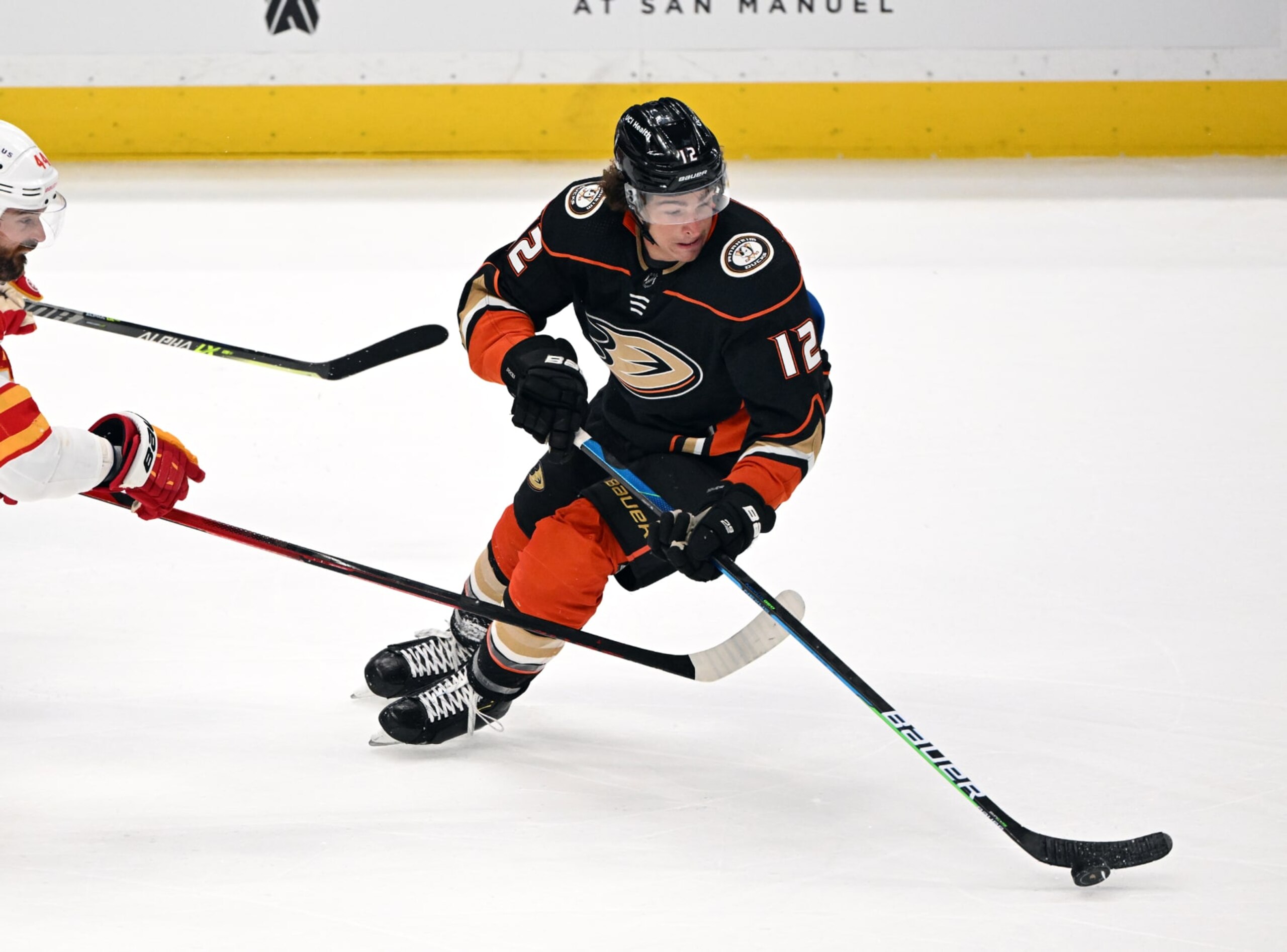 ANAHEIM, CA - APRIL 06: Anaheim Ducks left wing Sonny Milano (12) with the puck during the first period of an NHL hockey game against the Calgary Flames played on April 6, 2022 at the Honda Center in Anaheim, CA. (Photo by John Cordes/Icon Sportswire via Getty Images)