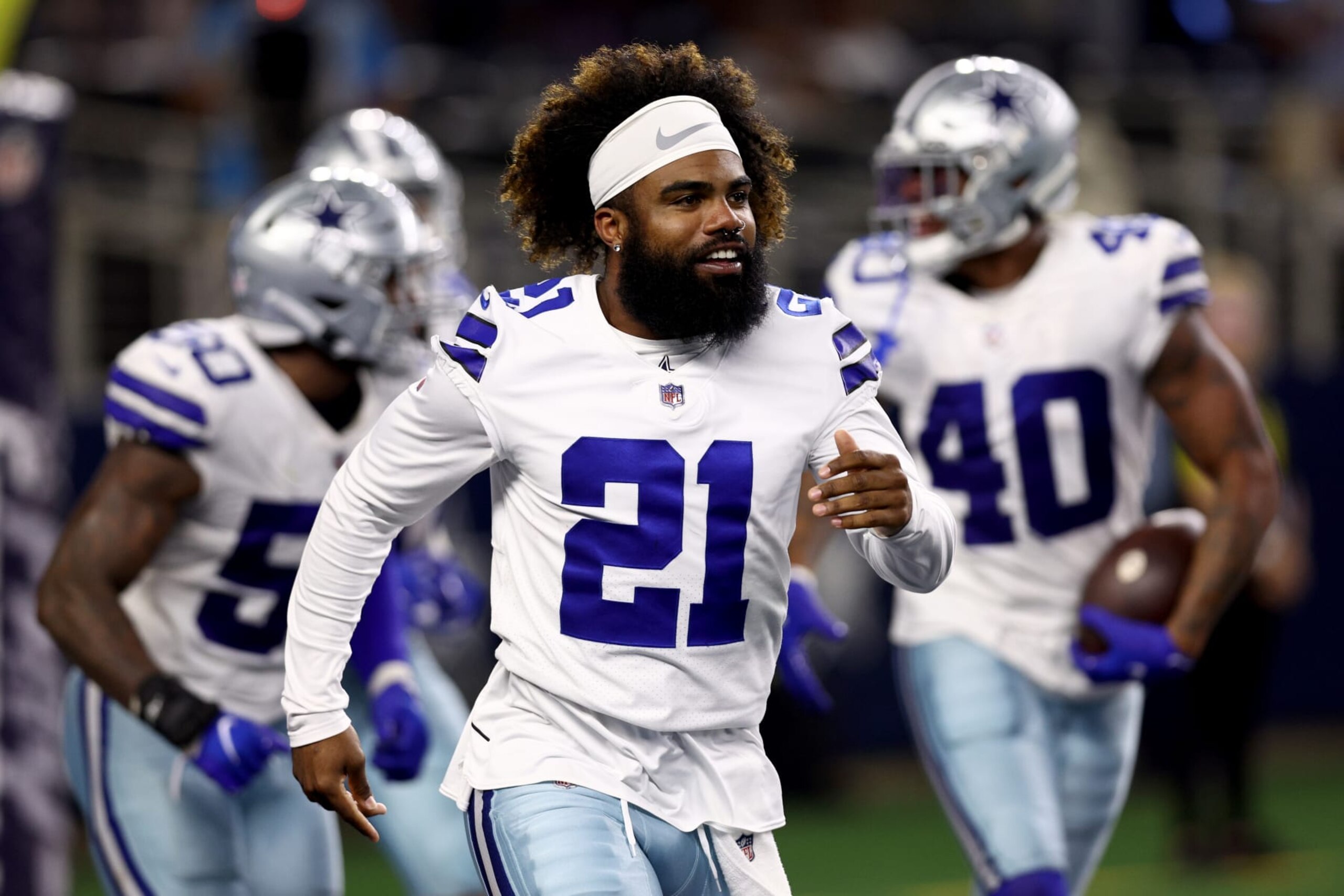 ARLINGTON, TEXAS - AUGUST 26: Running back Ezekiel Elliott #21 of the Dallas Cowboys celebrates after safety Juanyeh Thomas #40 of the Dallas Cowboys intercepted a pass thrown by quarterback Jacob Eason #17 of the Seattle Seahawks in the fourth quarter of a NFL preseason football game at AT&T Stadium on August 26, 2022 in Arlington, Texas. (Photo by Tom Pennington/Getty Images)